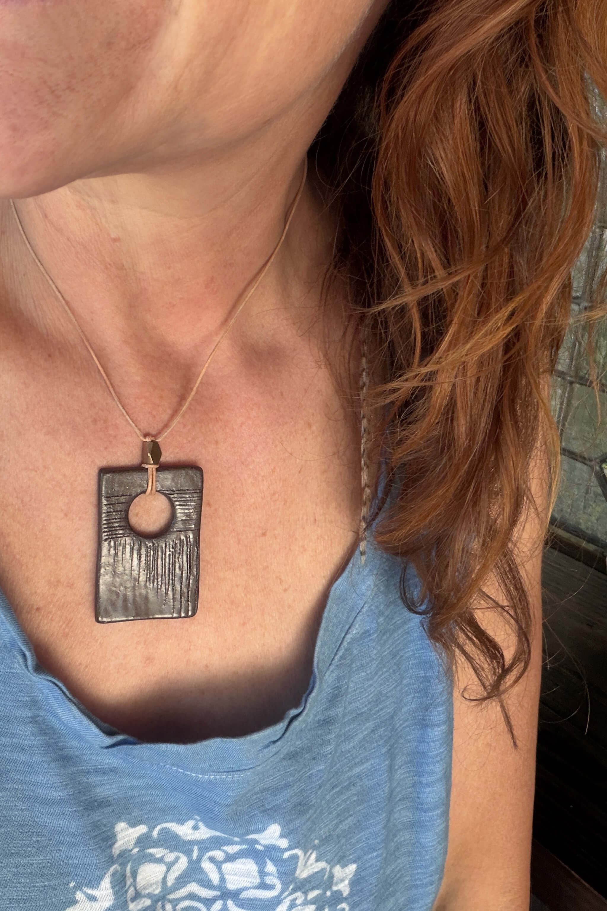 Handmade brown terracotta rectangle ceramic pendant necklace worn at shorter length — neutral modern ceramic jewelry From the Fire FTF_0726 by Jester Swink