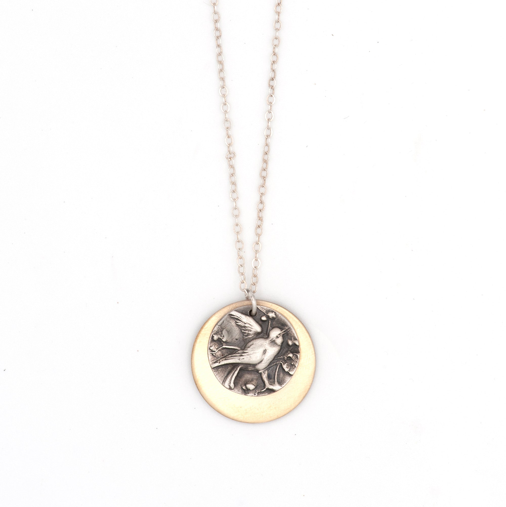 Handcrafted Birds of Flutter mixed metal charm necklace with silver bird and bronze disc on sterling silver chain, by Jester Swink