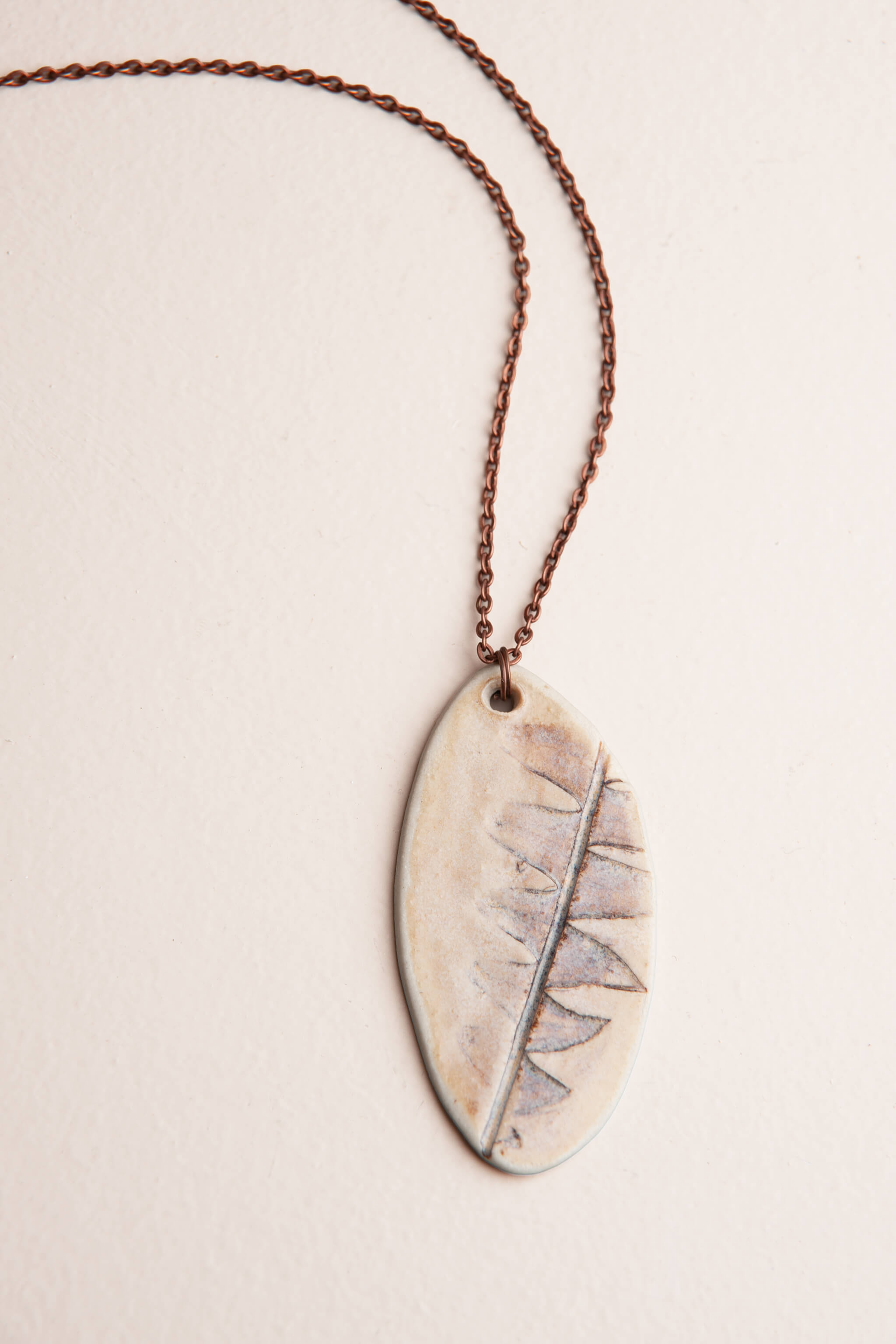 Handmade ceramic botanical pendant necklace with real protea leaf impression on copper chain, kiln fired by Jester Swink Santa Cruz Mountains — From the Fire FTF_0726