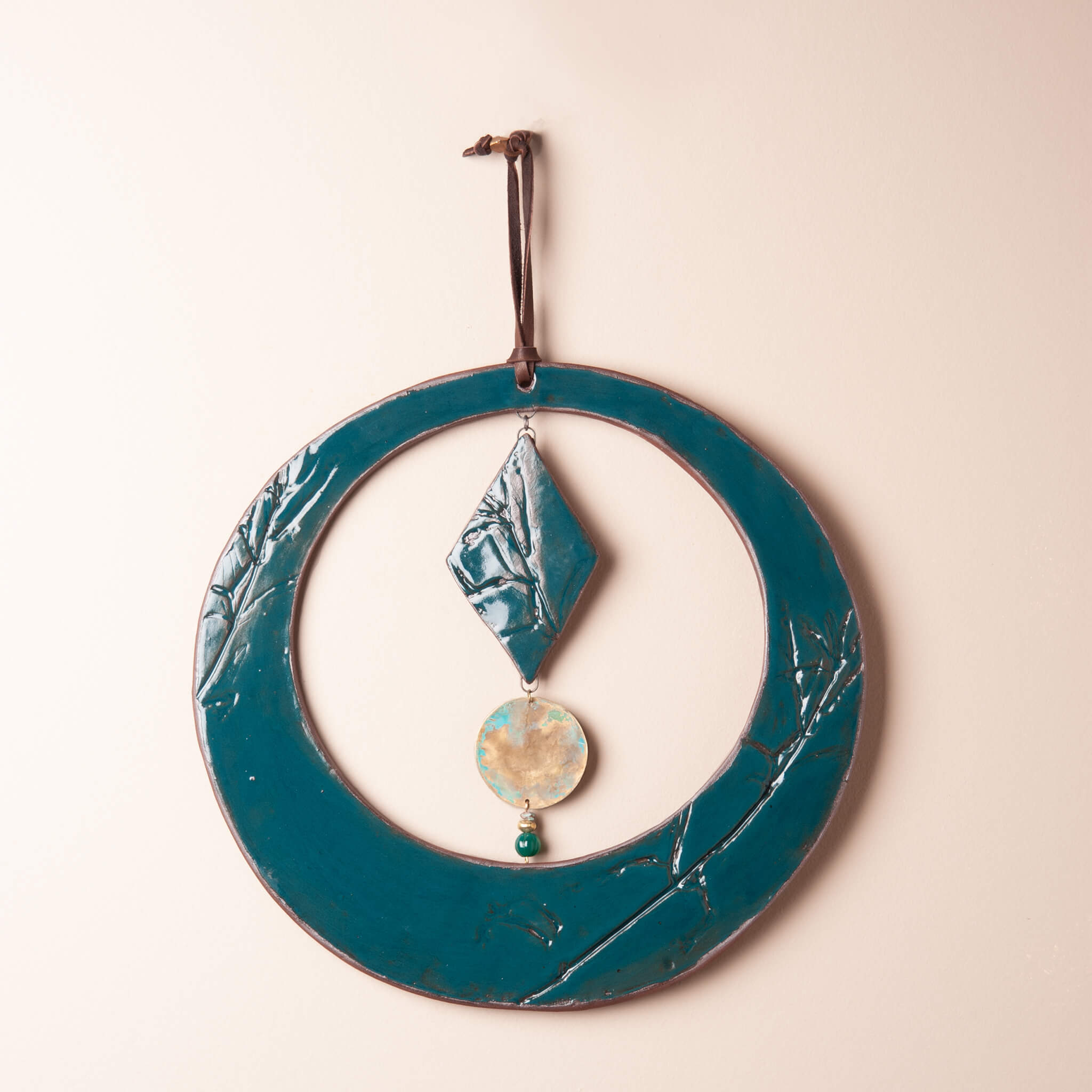 Handmade circle ceramic wall hanging in deep sea glaze with green onyx and brass disc, kiln fired by Jester Swink Santa Cruz Mountains — From the Fire FTF_0726