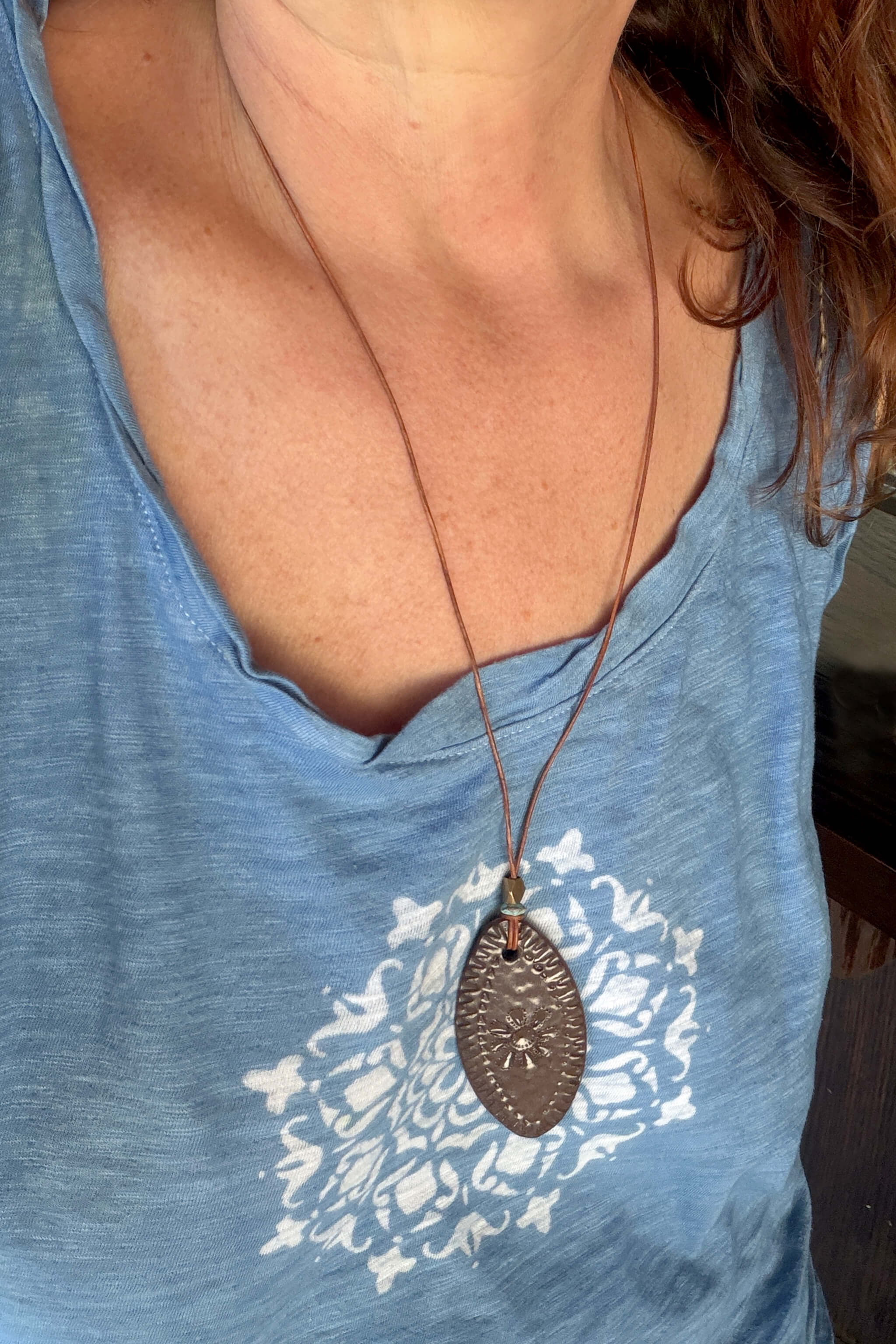 Handmade brown terracotta ceramic bloom pendant necklace worn at long boho length on Italian leather — southwest ceramic jewelry From the Fire FTF_0726 by Jester Swink