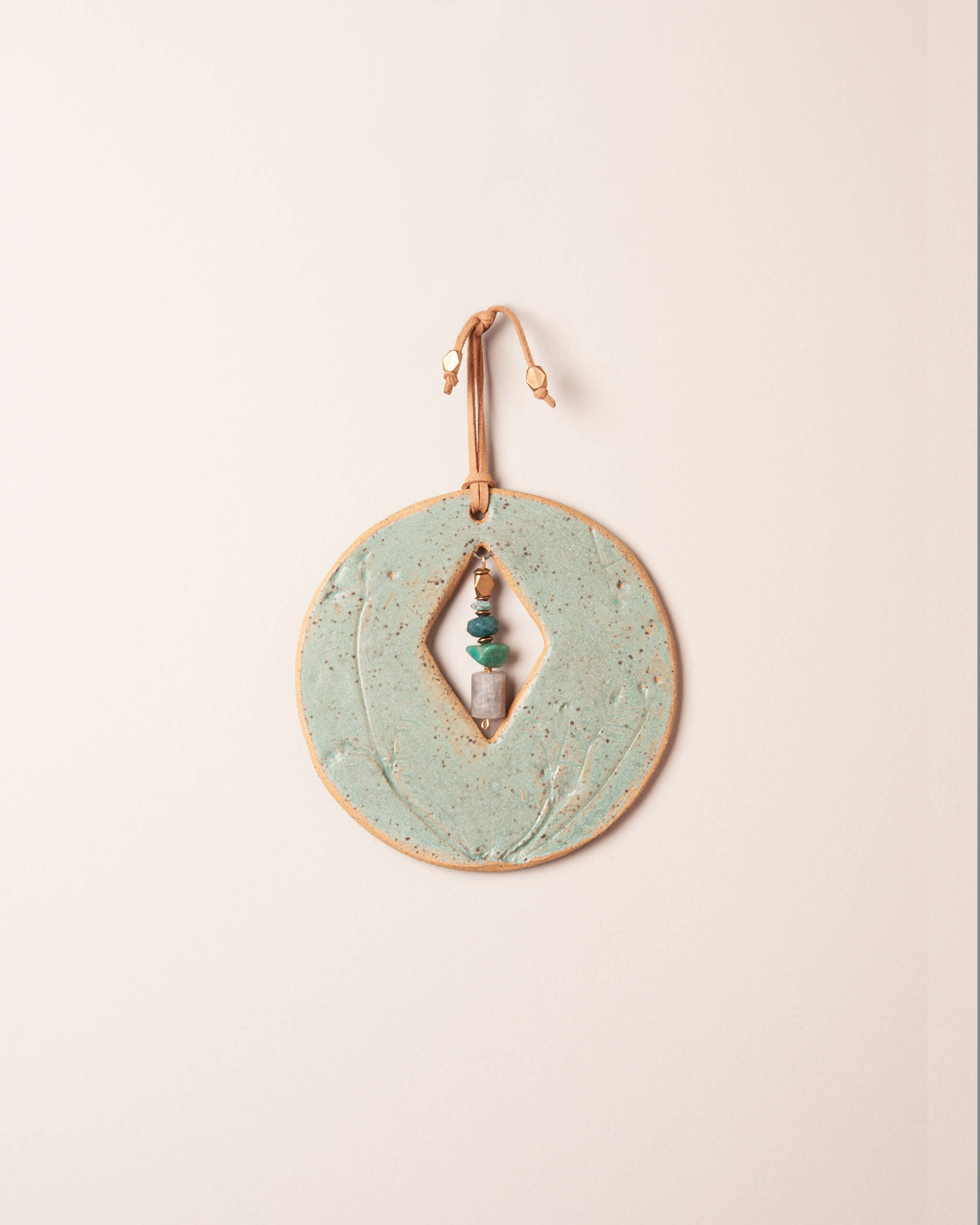 Cairn Diamond Moon handmade ceramic wall hanging with diamond center opening, wildflower impression and seafoam green glaze, made in the Santa Cruz Mountains of California