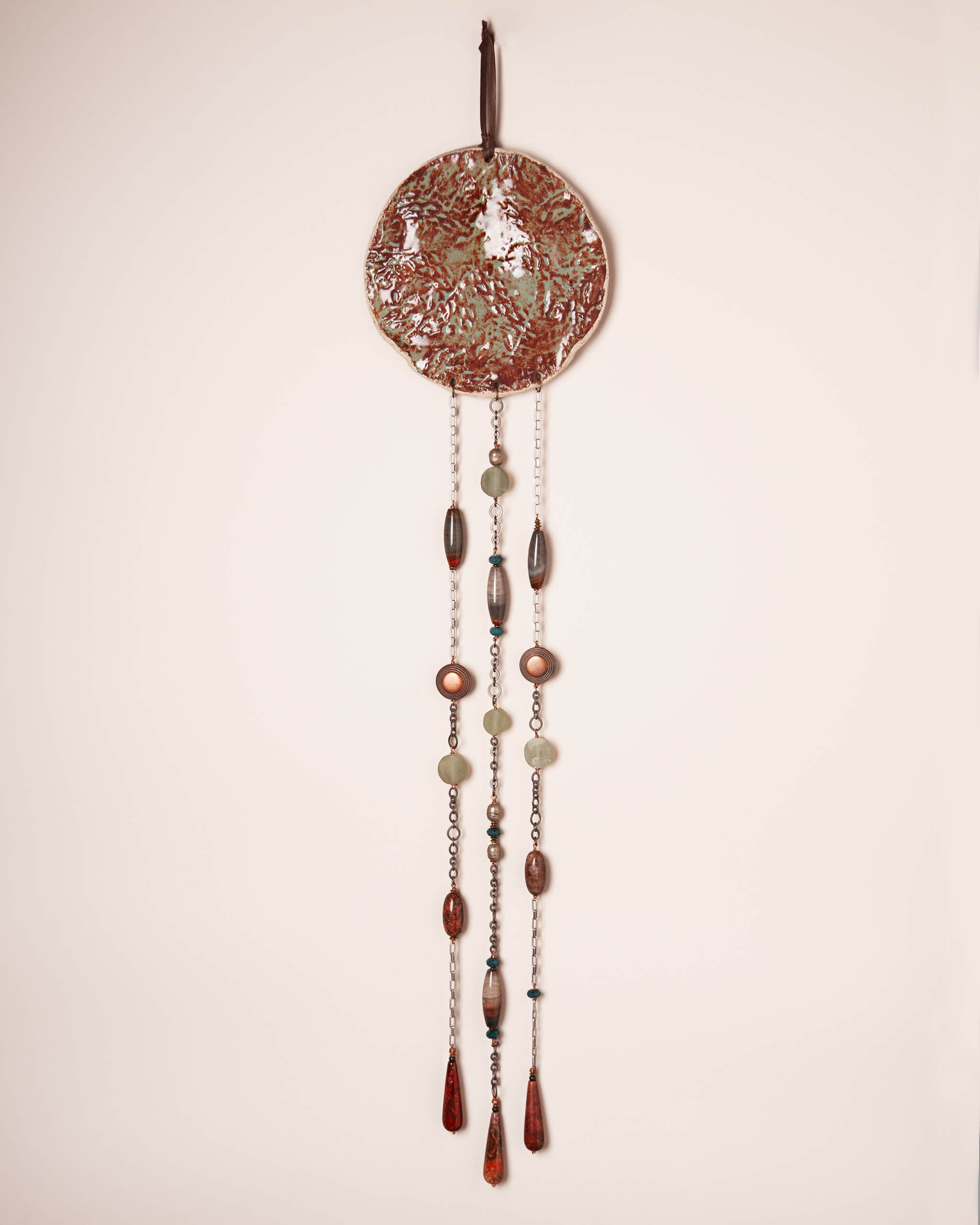 Redwood Rain large handmade ceramic wall hanging with redwood bark impression, rusty terracotta and sage glaze and three cascading stone strands, made in the Santa Cruz Mountains of California