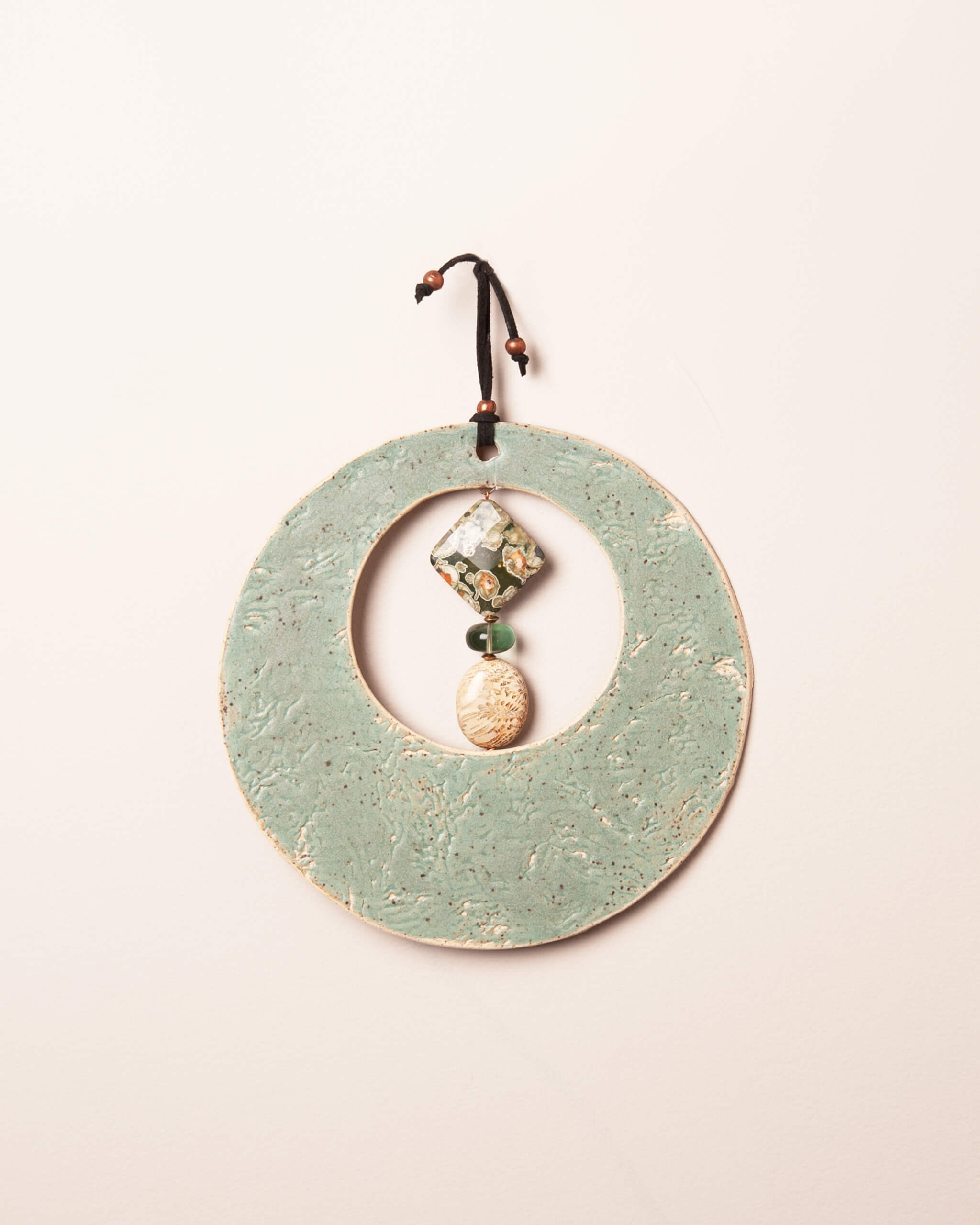 Sea Kelp Moon handmade ceramic wall hanging with sea kelp impression and seafoam glaze, made in the Santa Cruz Mountains of California