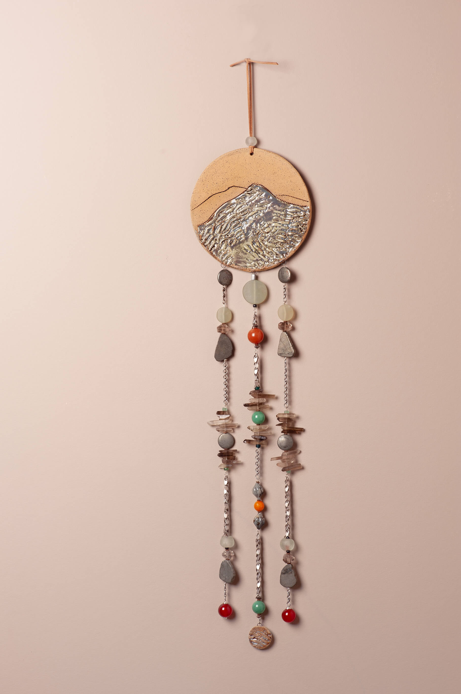 Handcrafted ceramic mountain wall hanging with carved peaks, pyrite, carnelian, jade, and sea glass stones cascading on silver chain, artisan wall art by Jester Swink