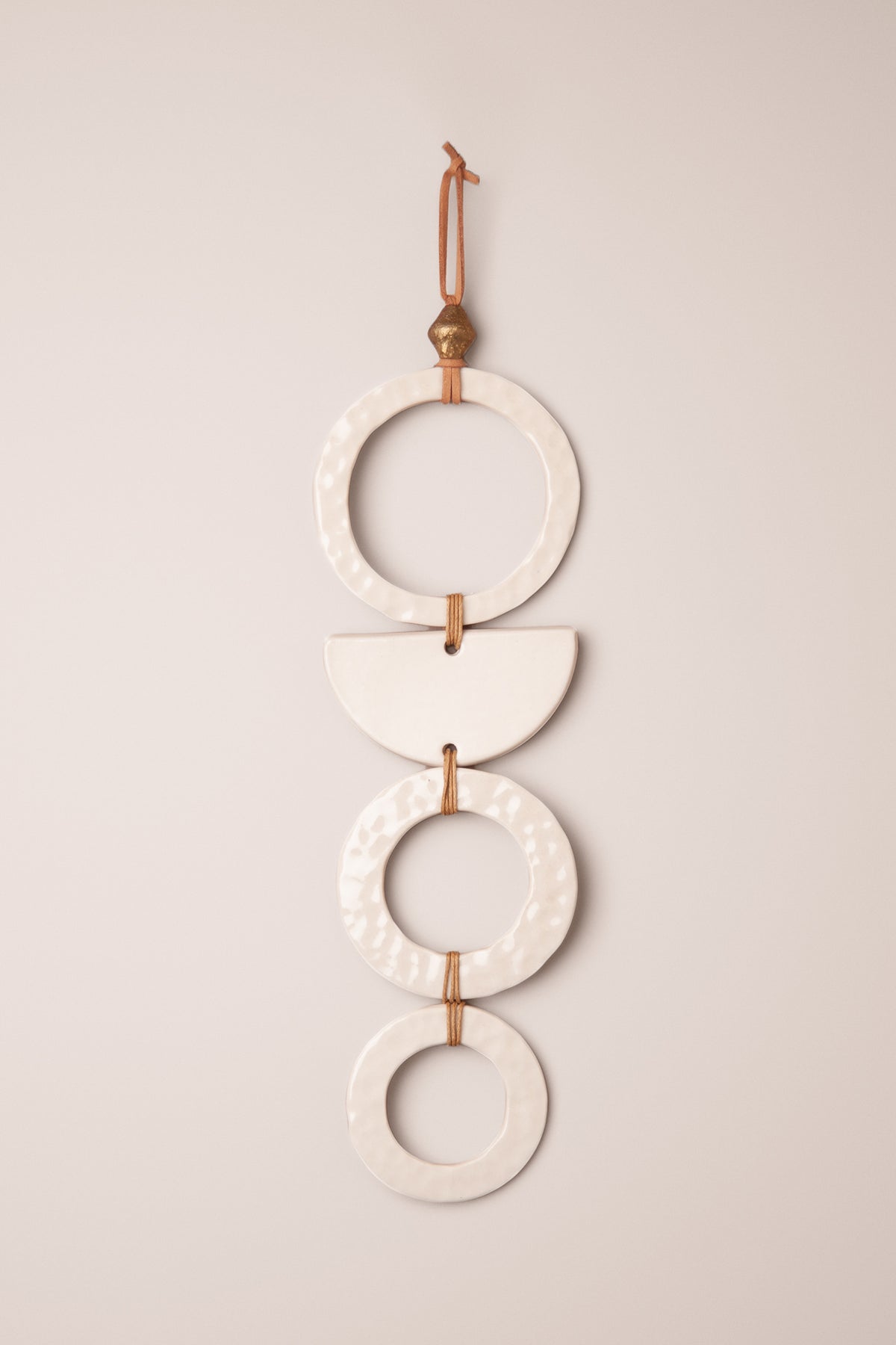Large handmade tiered porcelain wall hanging with three moon textured rings and a half moon in a clean gloss glaze with a brass bead, kiln fired by Jester Swink Santa Cruz Mountains — From the Fire FTF_1026