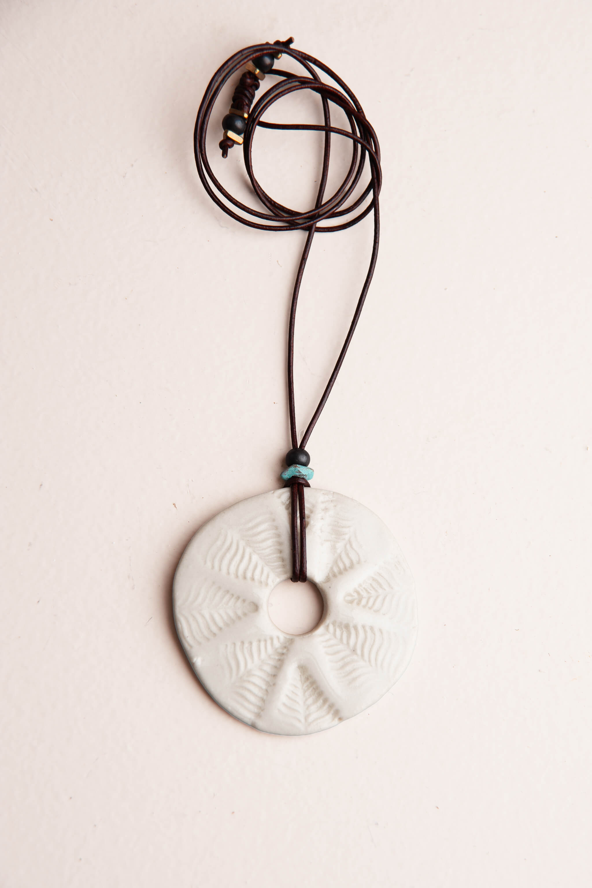 Handmade white porcelain leaf mandala ceramic pendant necklace on chocolate Italian leather with turquoise accent bead, kiln fired by Jester Swink Santa Cruz Mountains — From the Fire FTF_0726