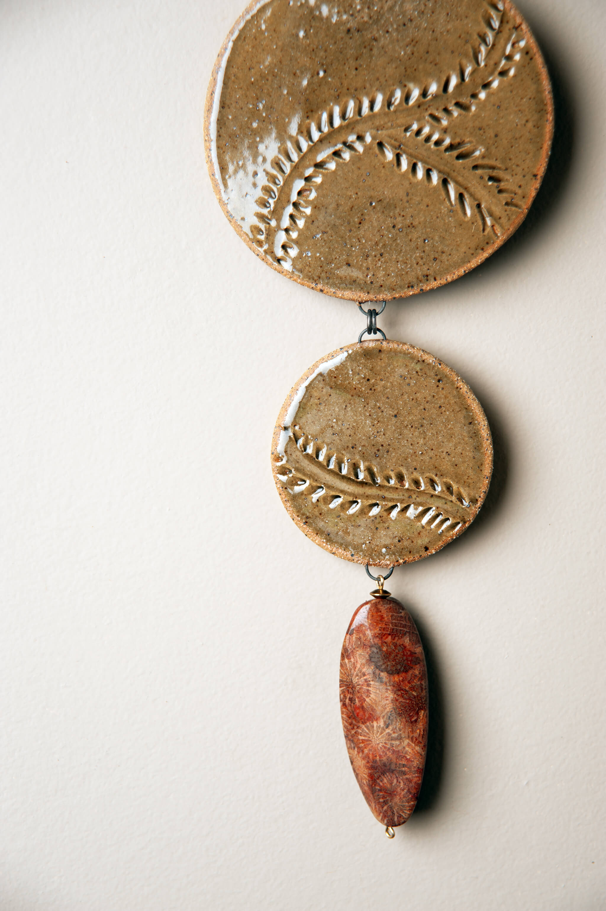Fossilized coral agate drop and brass accents on handmade cascading ceramic wall hanging From the Fire FTF_0726 by Jester Swink