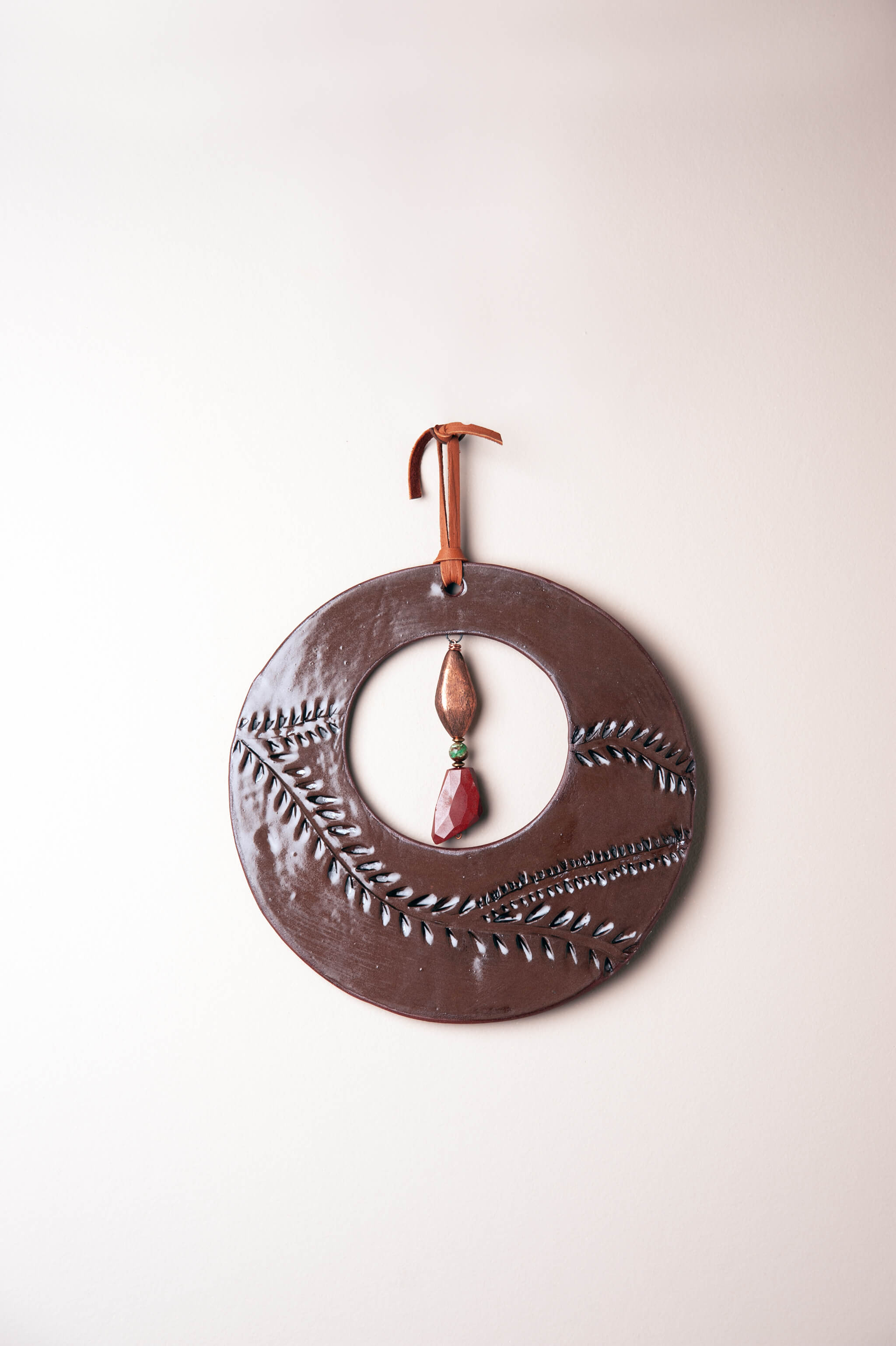 Medium handmade circle ceramic wall art in rich chocolate brown with vine leaf pattern, chrysoprase and jasper drop, kiln fired by Jester Swink Santa Cruz Mountains — From the Fire FTF_0726