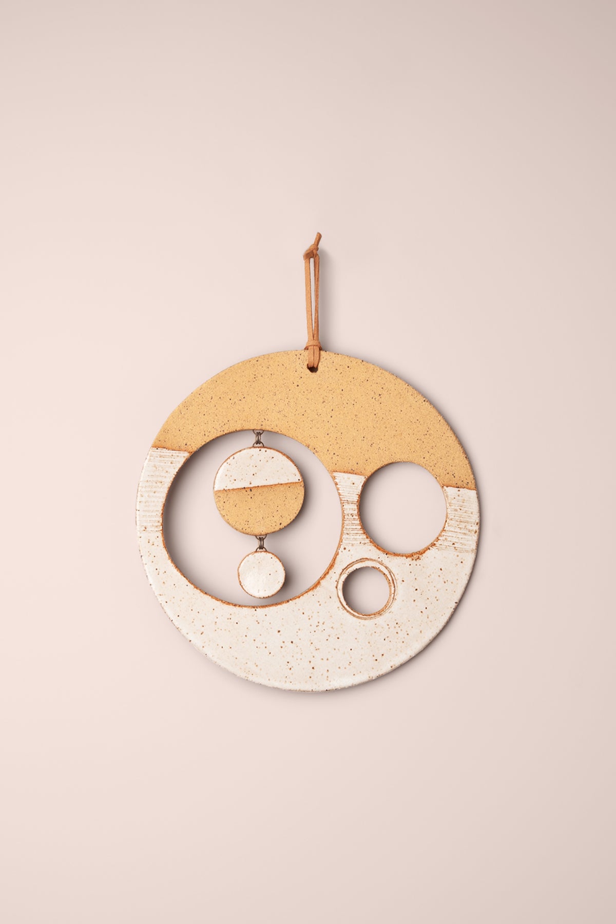 Medium handmade circle ceramic wall hanging in white glaze over warm speckled clay with round windows and small hanging moons, kiln fired by Jester Swink Santa Cruz Mountains — From the Fire FTF_1026