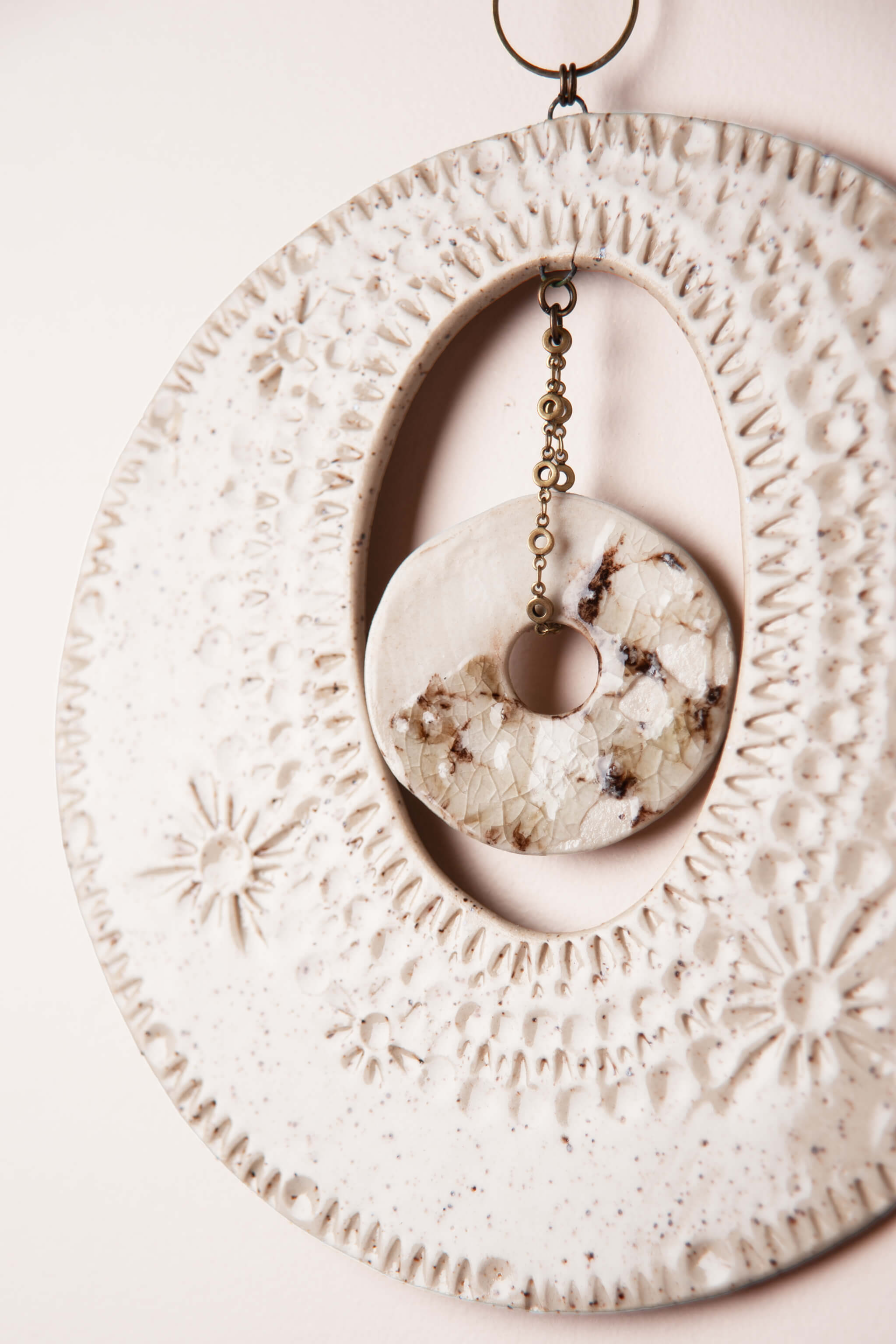 Detail of hand impressed flower and abstract pattern on modern coastal natural wall hanging by Jester Swink, Santa Cruz Mountains California