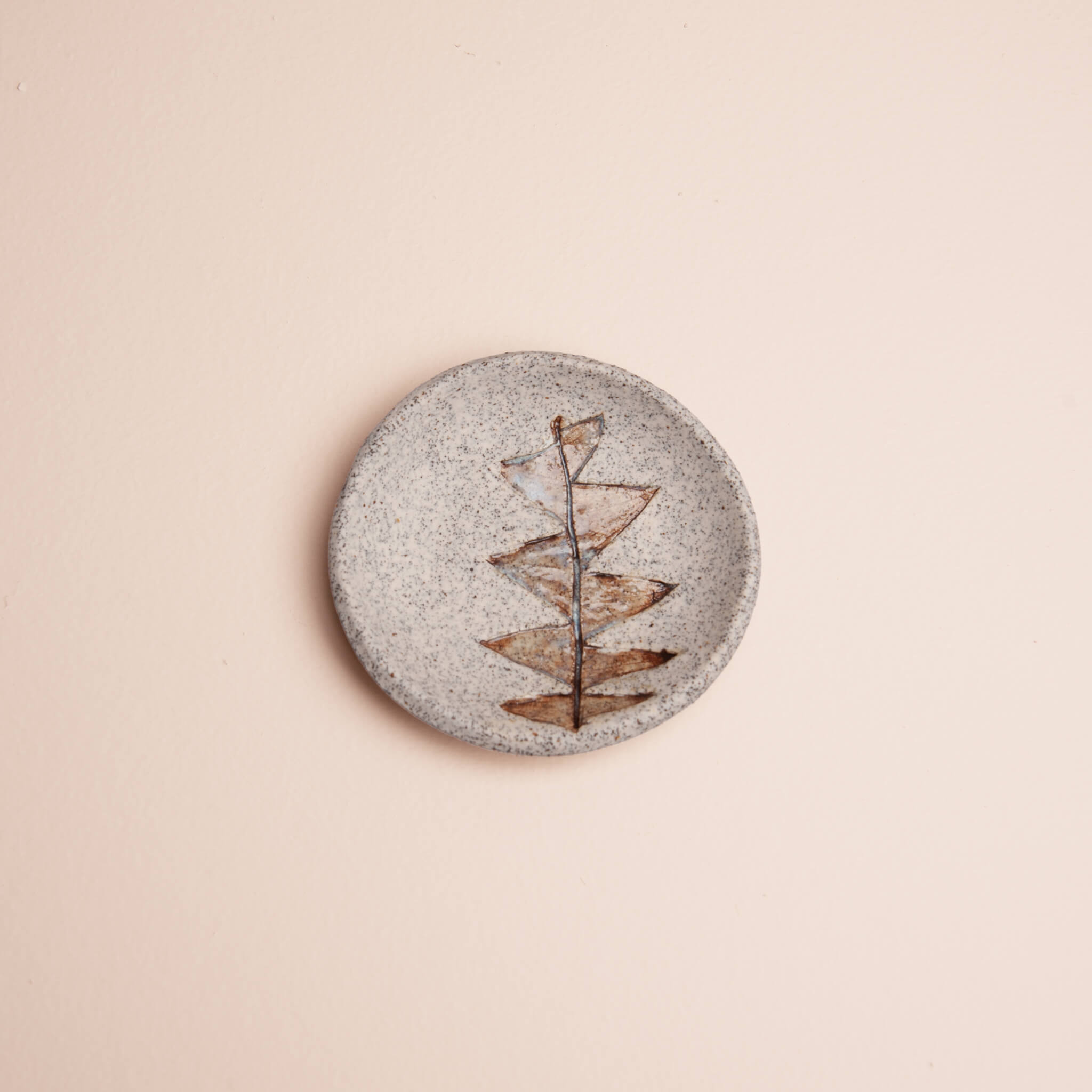 Overhead view of handmade ceramic Protea Leaf ring dish with painterly brown glaze and blue tint on dragon fruit clay, by Jester Swink