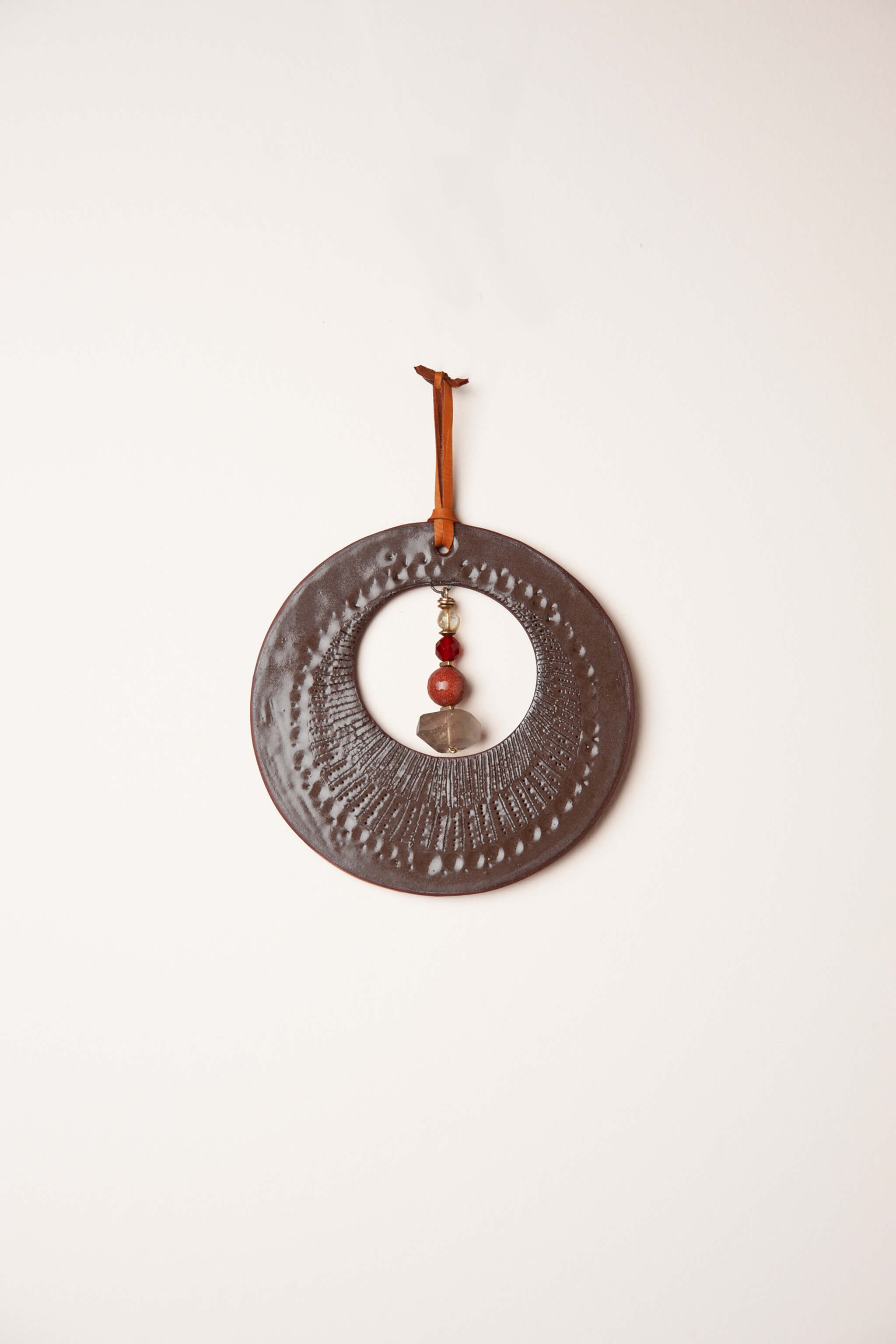 Small handmade ceramic circle wall hanging in chocolate brown with citrine carnelian and smoky quartz, kiln fired by Jester Swink Santa Cruz Mountains — From the Fire FTF_0726