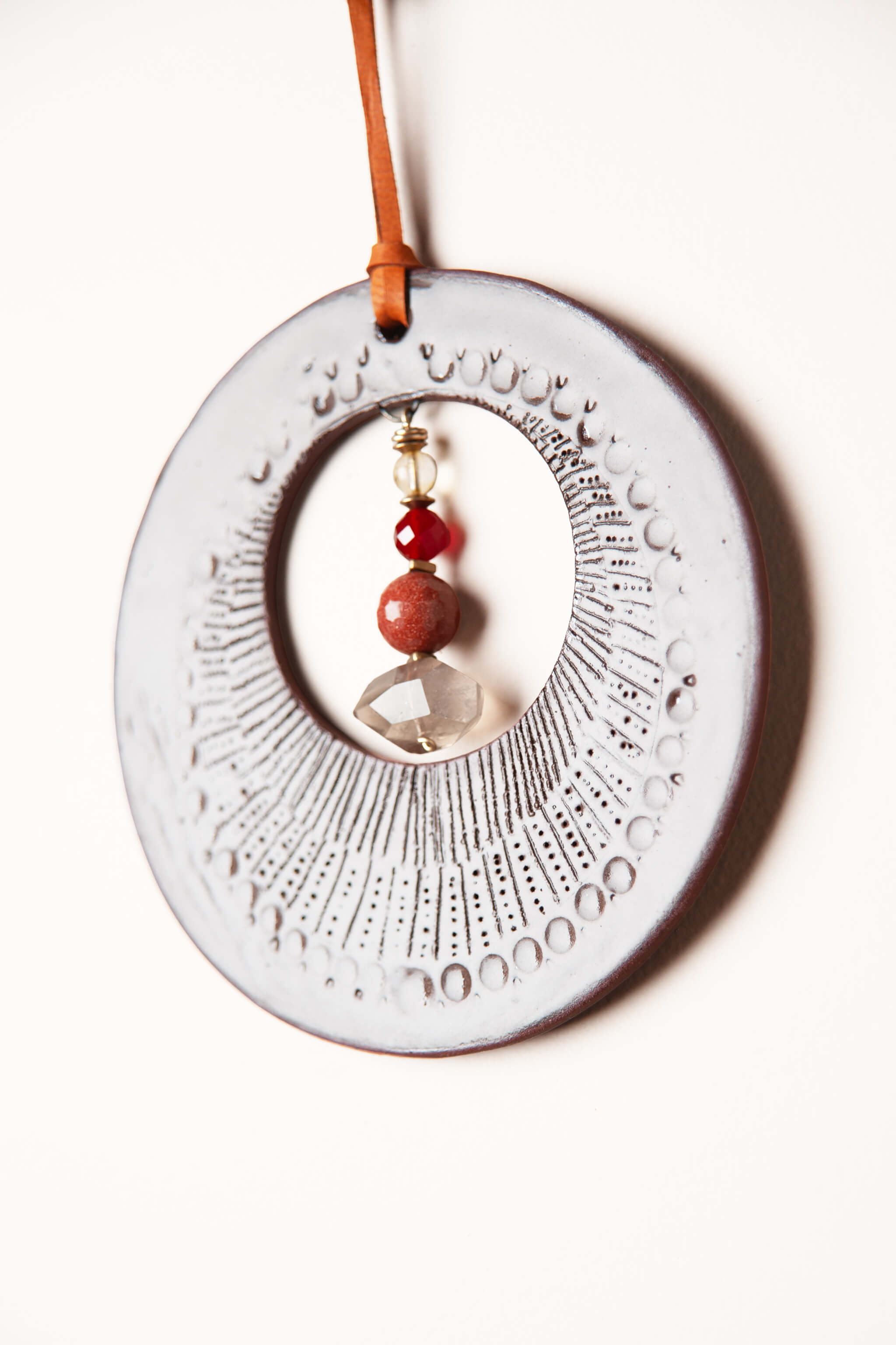 Citrine carnelian sandstone and smoky quartz suspended on small handmade ceramic boho wall hanging From the Fire FTF_0726 by Jester Swink