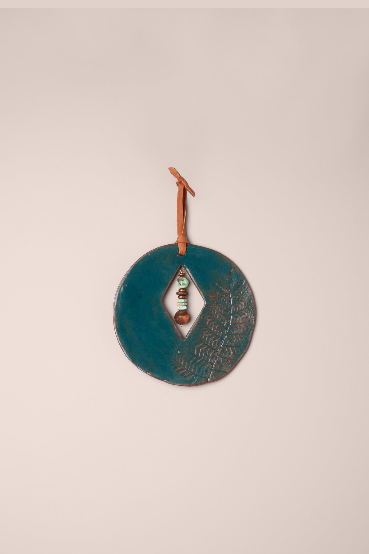 Small handmade circle ceramic wall hanging in Emerald glaze with a real fern impression and a chrysoprase and turquoise dangle, kiln fired by Jester Swink Santa Cruz Mountains — From the Fire FTF_1026