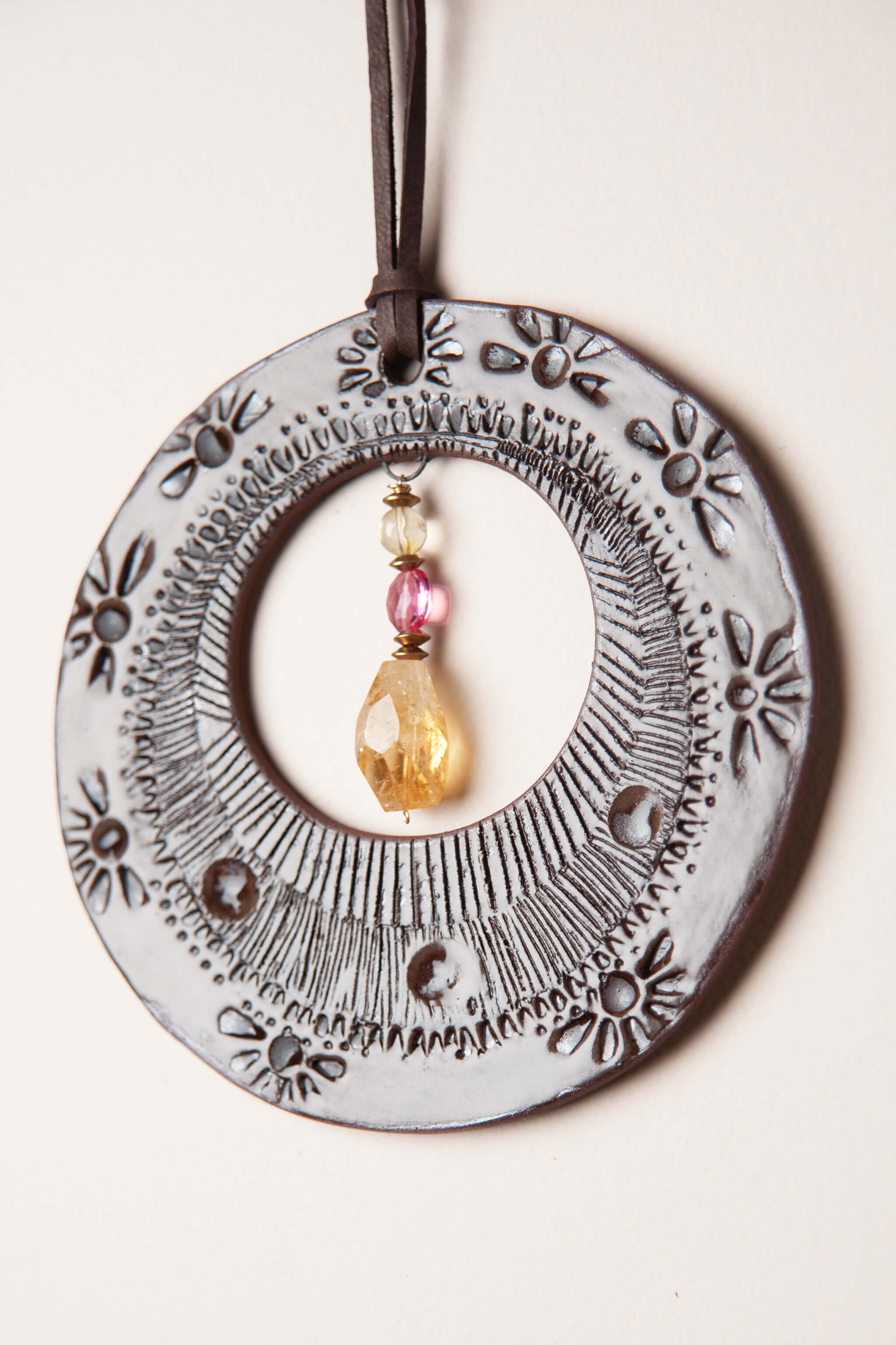 Rubelite tourmaline and citrine with brass accents on small handmade southwest ceramic wall hanging From the Fire FTF_0726 by Jester Swink
