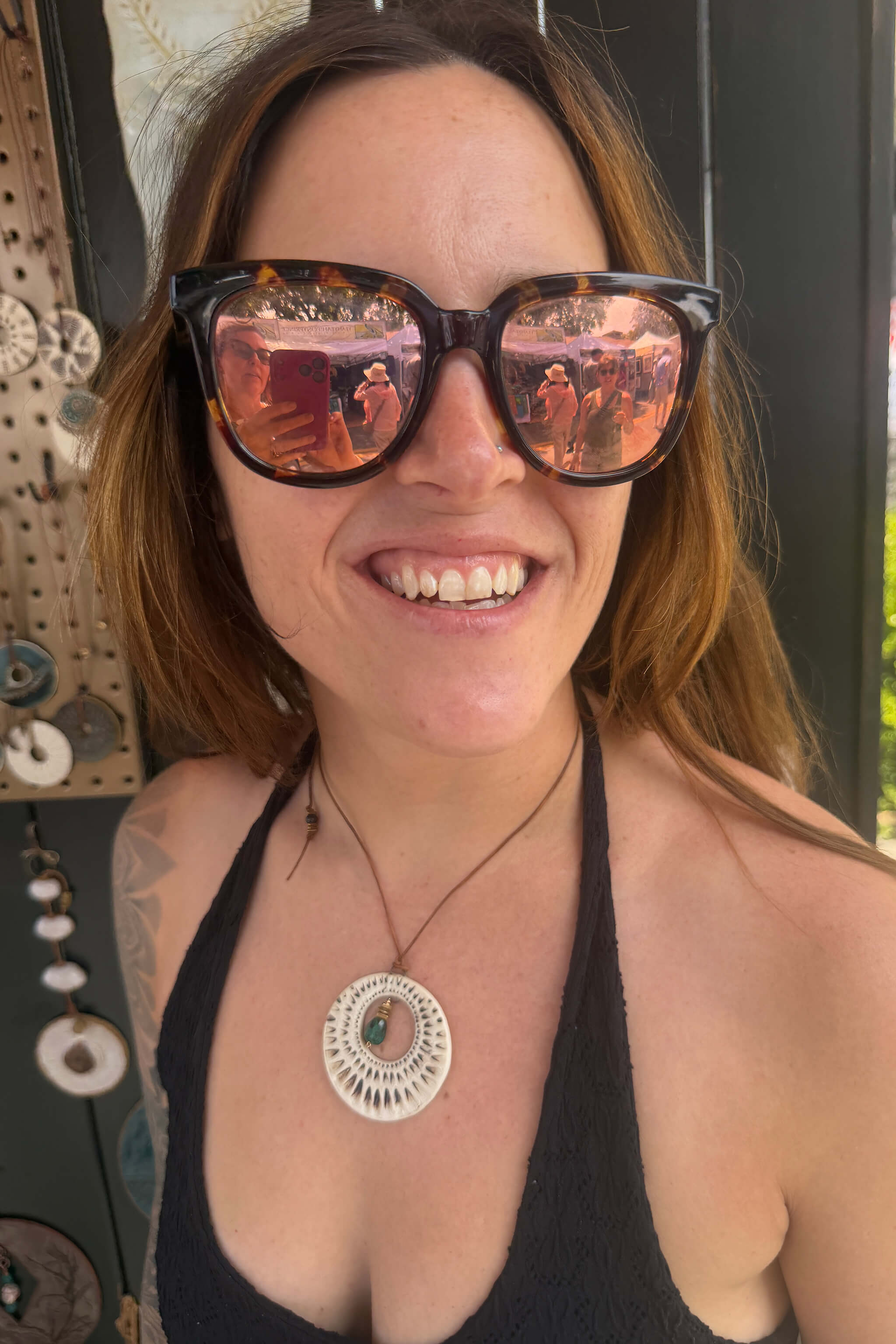 Handmade sunburst pendant necklace in ivory worn by collector at Los Altos Art and Wine Festival — From the Fire FTF_0726 by Jester Swink