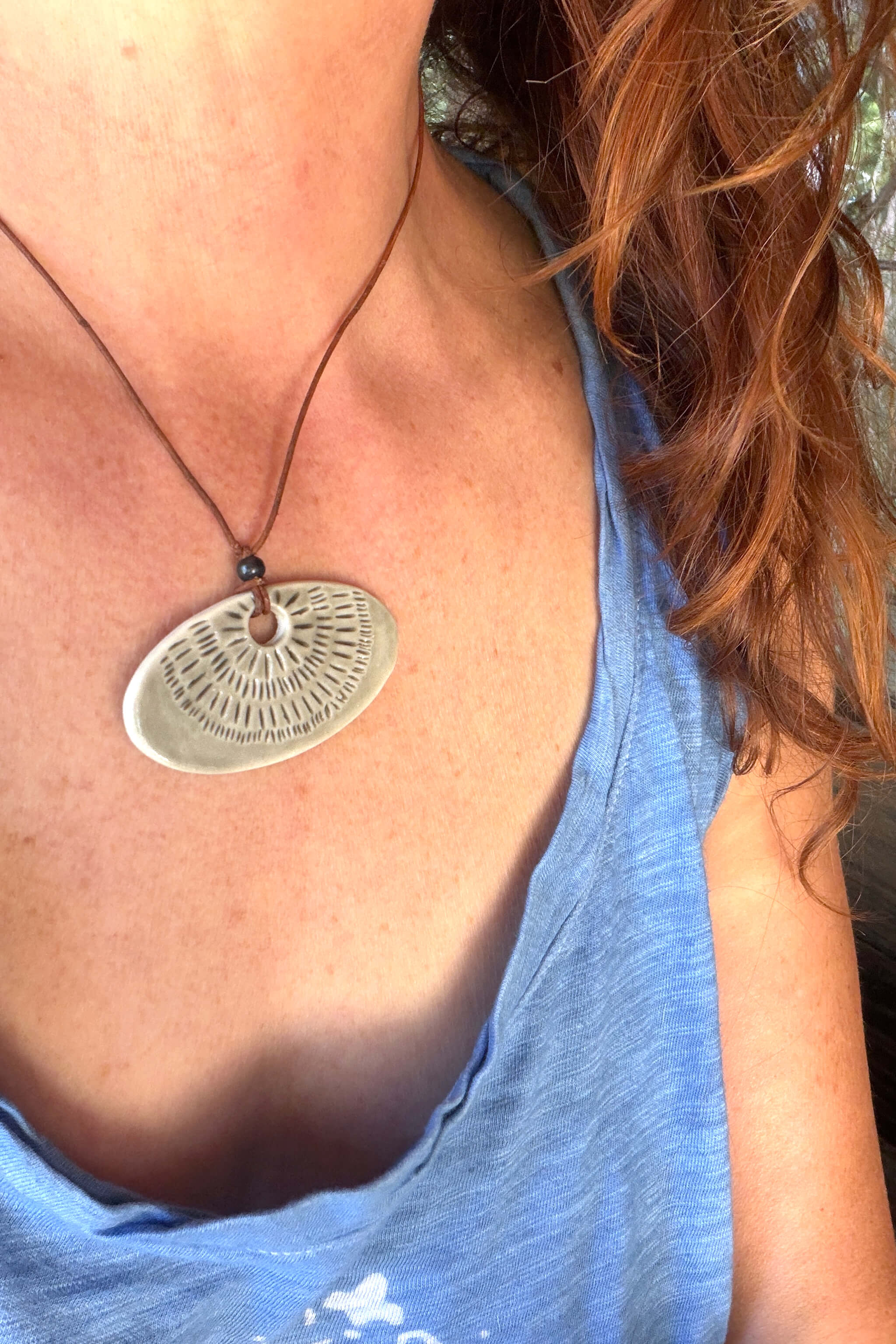 Handmade smoke grey ceramic sunray pendant necklace worn at shorter length — neutral minimalist ceramic jewelry From the Fire FTF_0726 by Jester Swink
