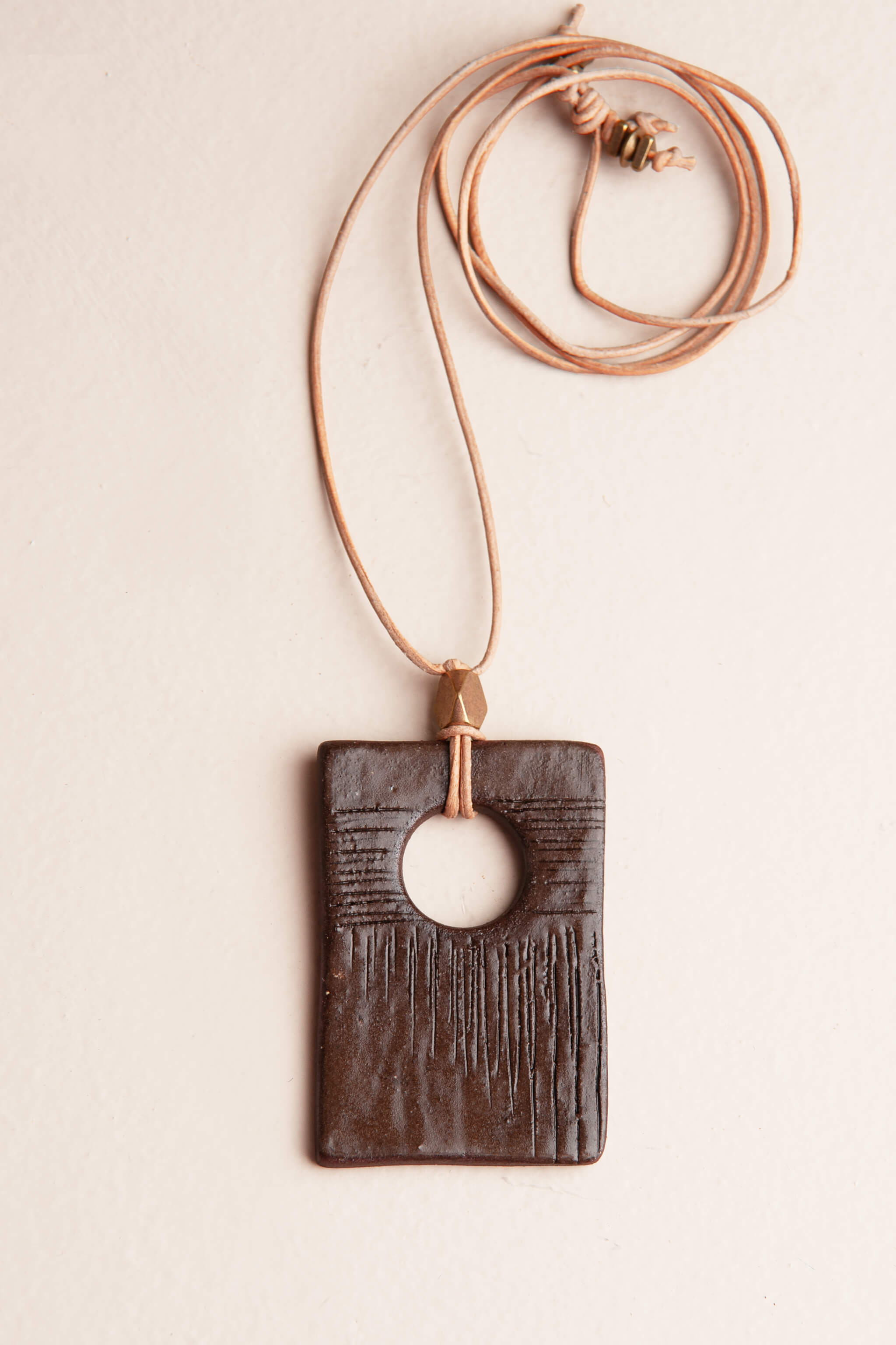 Handmade chocolate terracotta rectangle ceramic pendant necklace with abstract carved lines on natural Italian leather, kiln fired by Jester Swink Santa Cruz Mountains — From the Fire FTF_0726