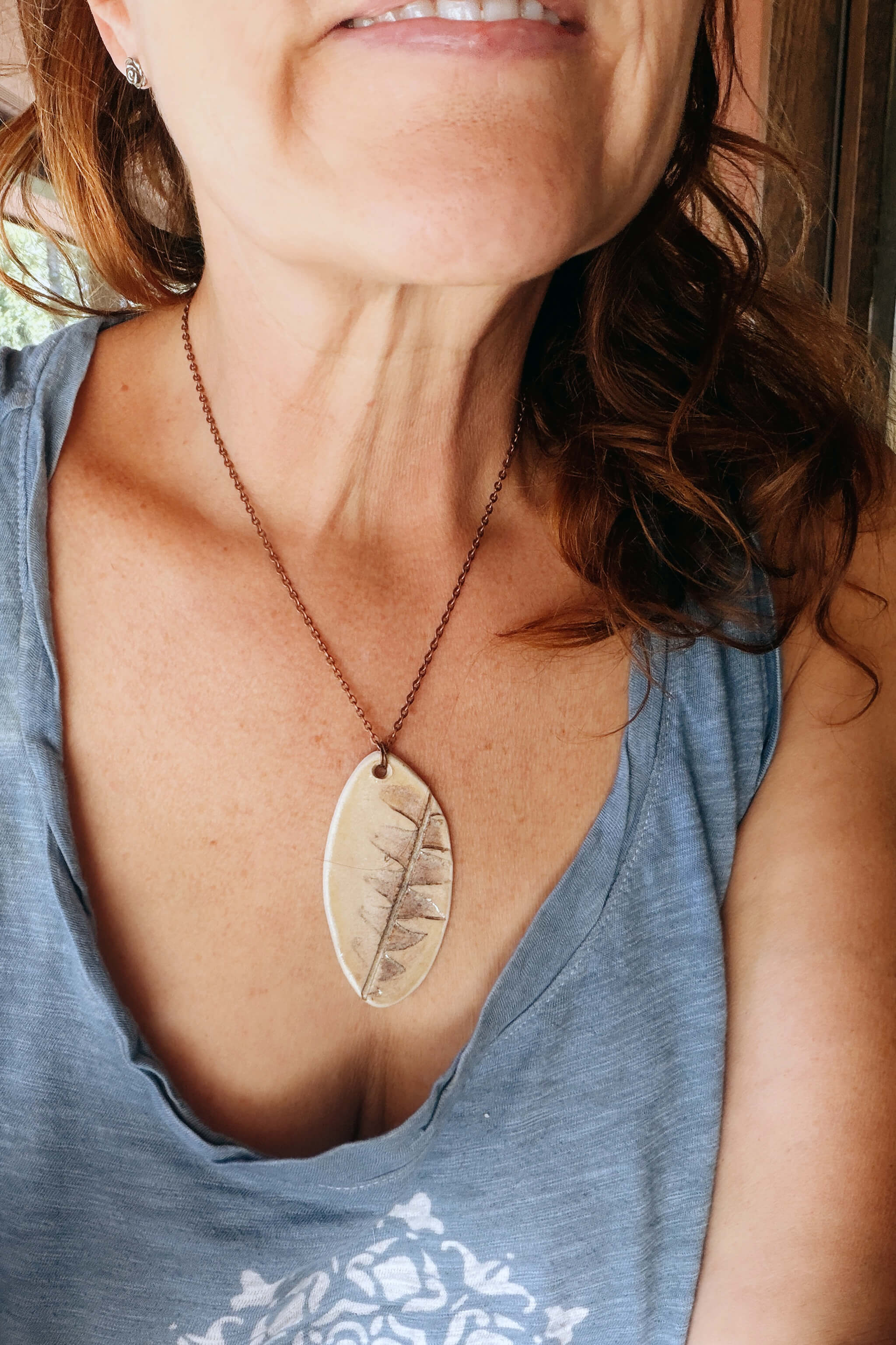 Handmade ceramic protea leaf pendant necklace worn on copper chain — botanical ceramic jewelry From the Fire FTF_0726 by Jester Swink