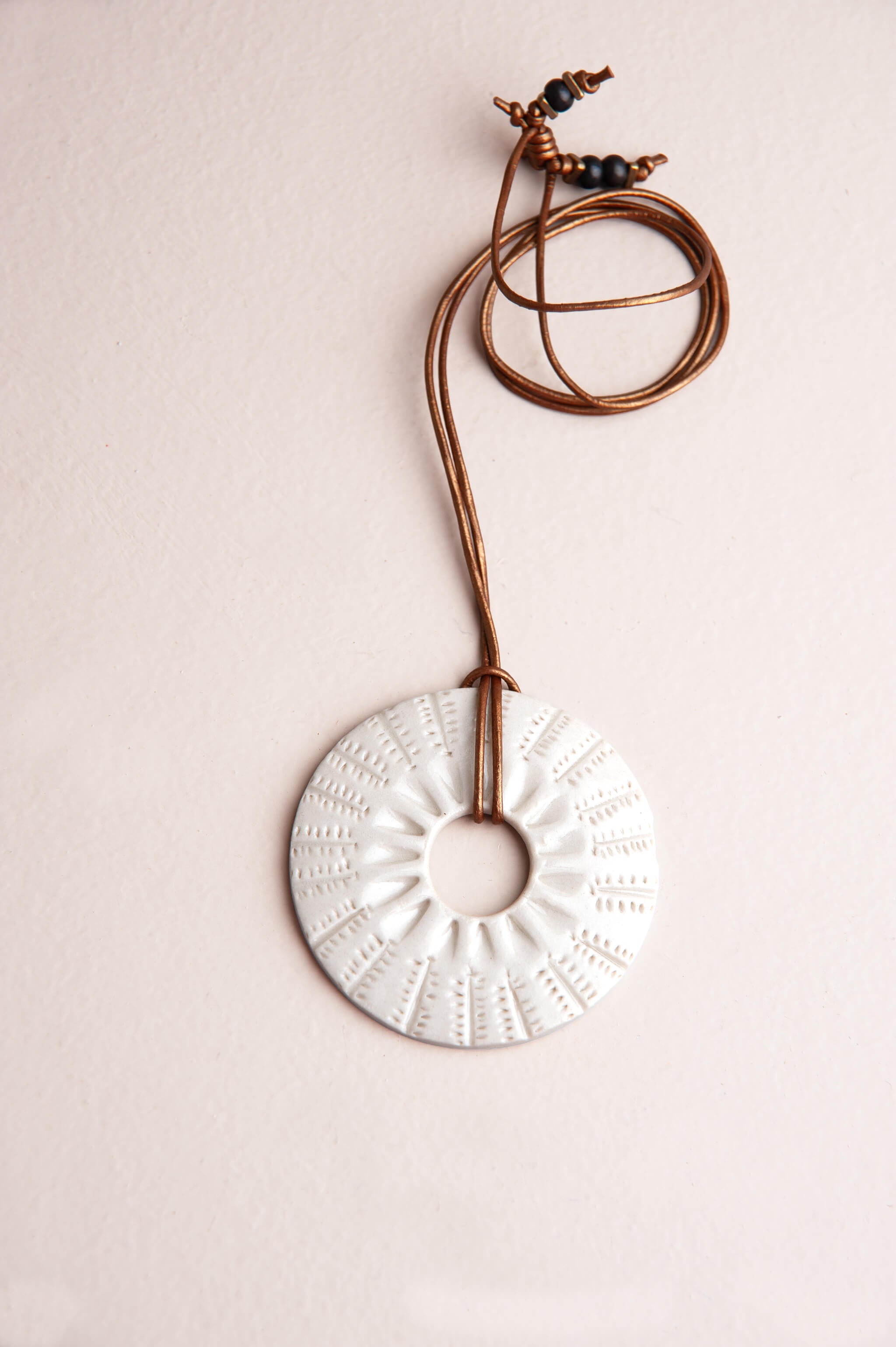 Handmade white porcelain botanical sunburst ceramic pendant necklace on gold metallic Italian leather, kiln fired by Jester Swink Santa Cruz Mountains — From the Fire FTF_0726