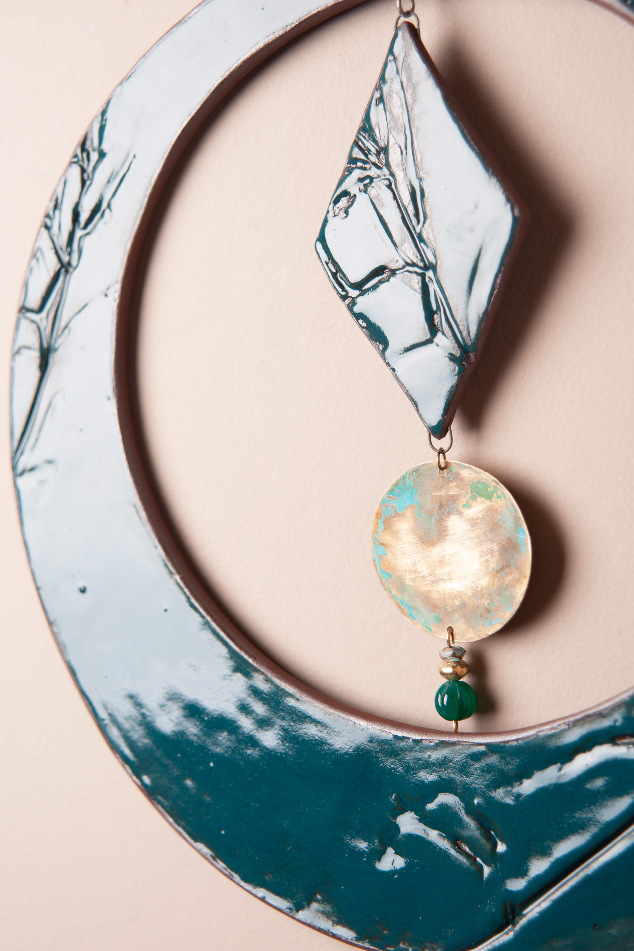 Hand-patinated brass disc and green onyx drop on handmade ceramic round wall hanging — Jester Swink From the Fire FTF_0726