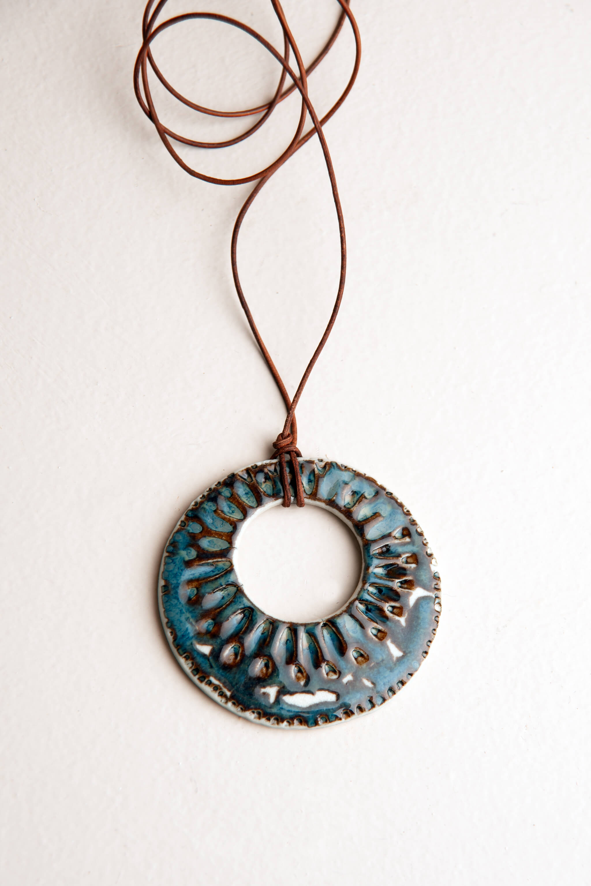Handmade coastal ceramic ring pendant necklace in ocean blue and brown glaze on Italian leather, kiln fired by Jester Swink Santa Cruz Mountains — From the Fire FTF_0726