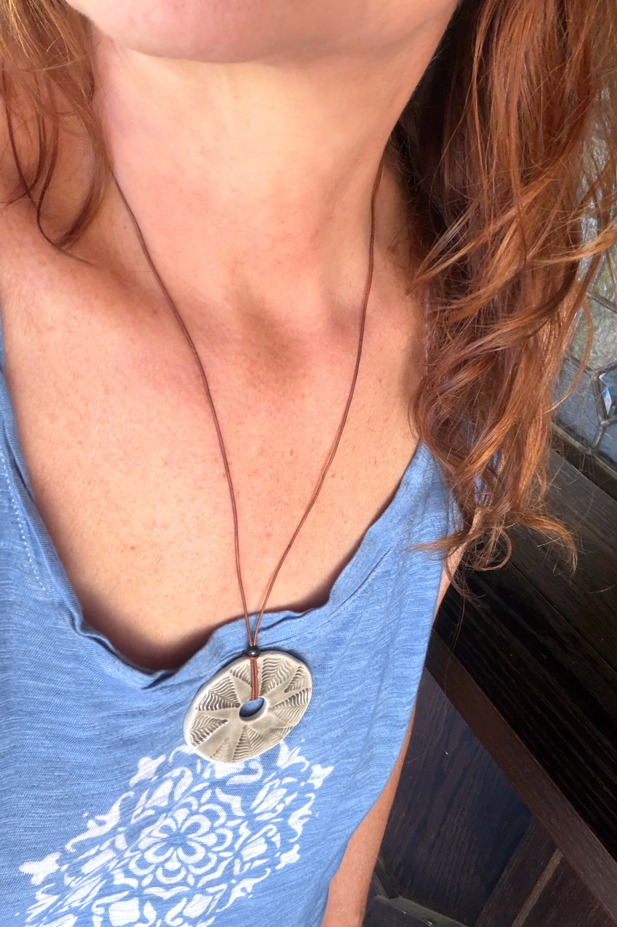 Handmade grey porcelain fern leaf ceramic pendant necklace worn at long boho length on brown leather — botanical ceramic jewelry From the Fire FTF_0726 by Jester Swink