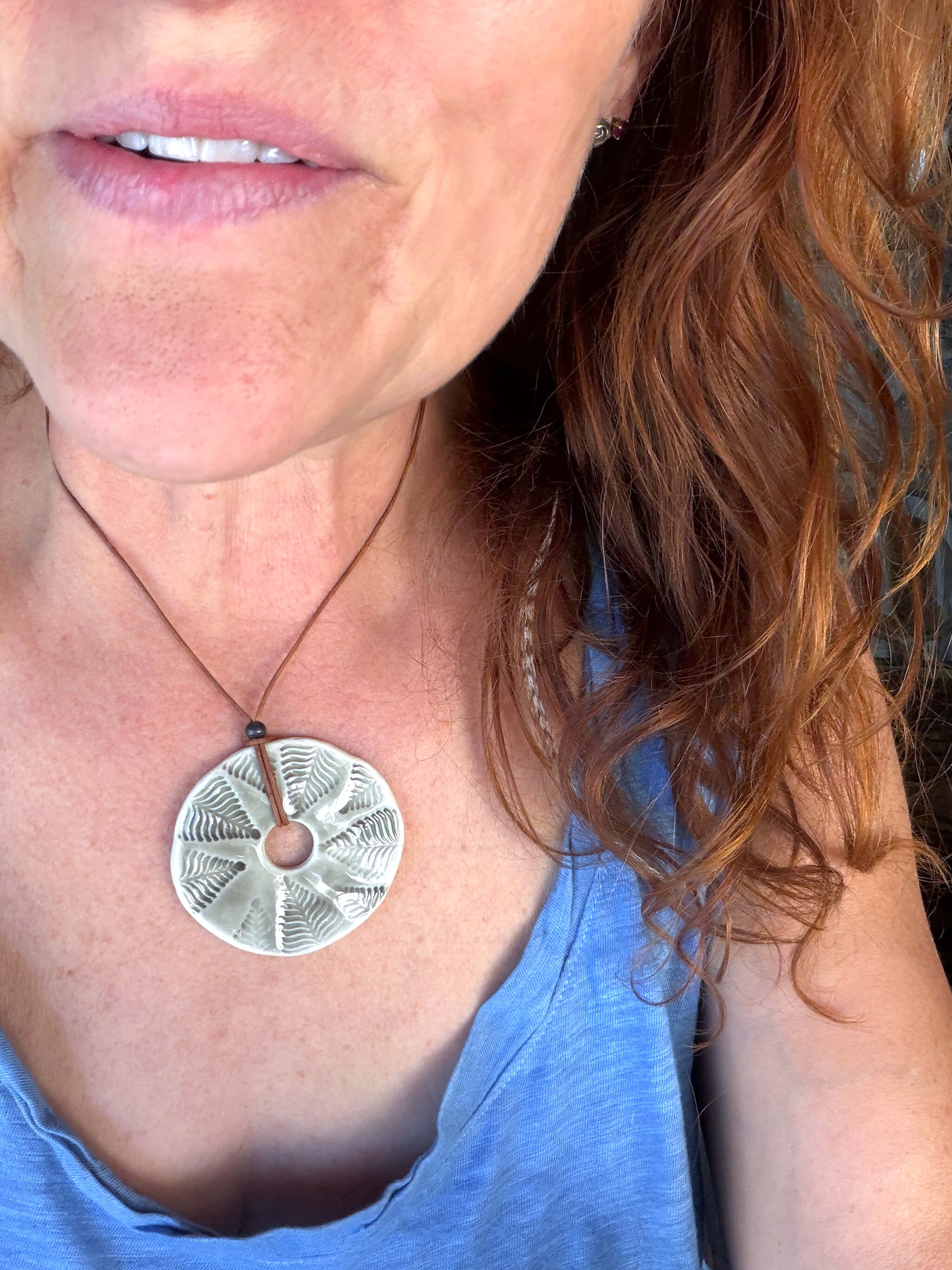 Handmade smoke grey ceramic fern fossil pendant necklace worn at shorter length — nature inspired ceramic jewelry From the Fire FTF_0726 by Jester Swink