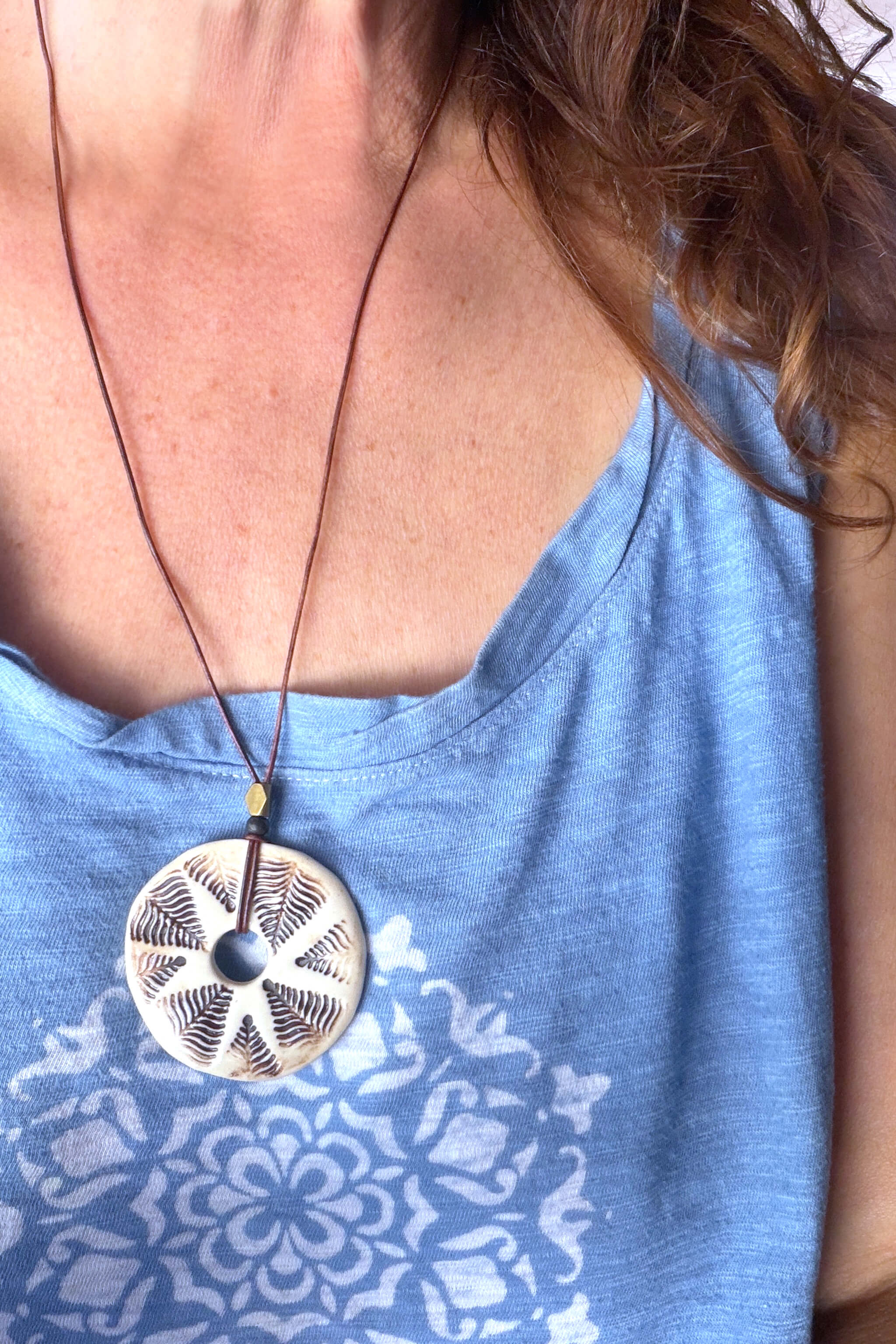 Handmade porcelain fern leaf ceramic pendant necklace worn at long boho length on brown leather — botanical ceramic jewelry From the Fire FTF_0726 by Jester Swink