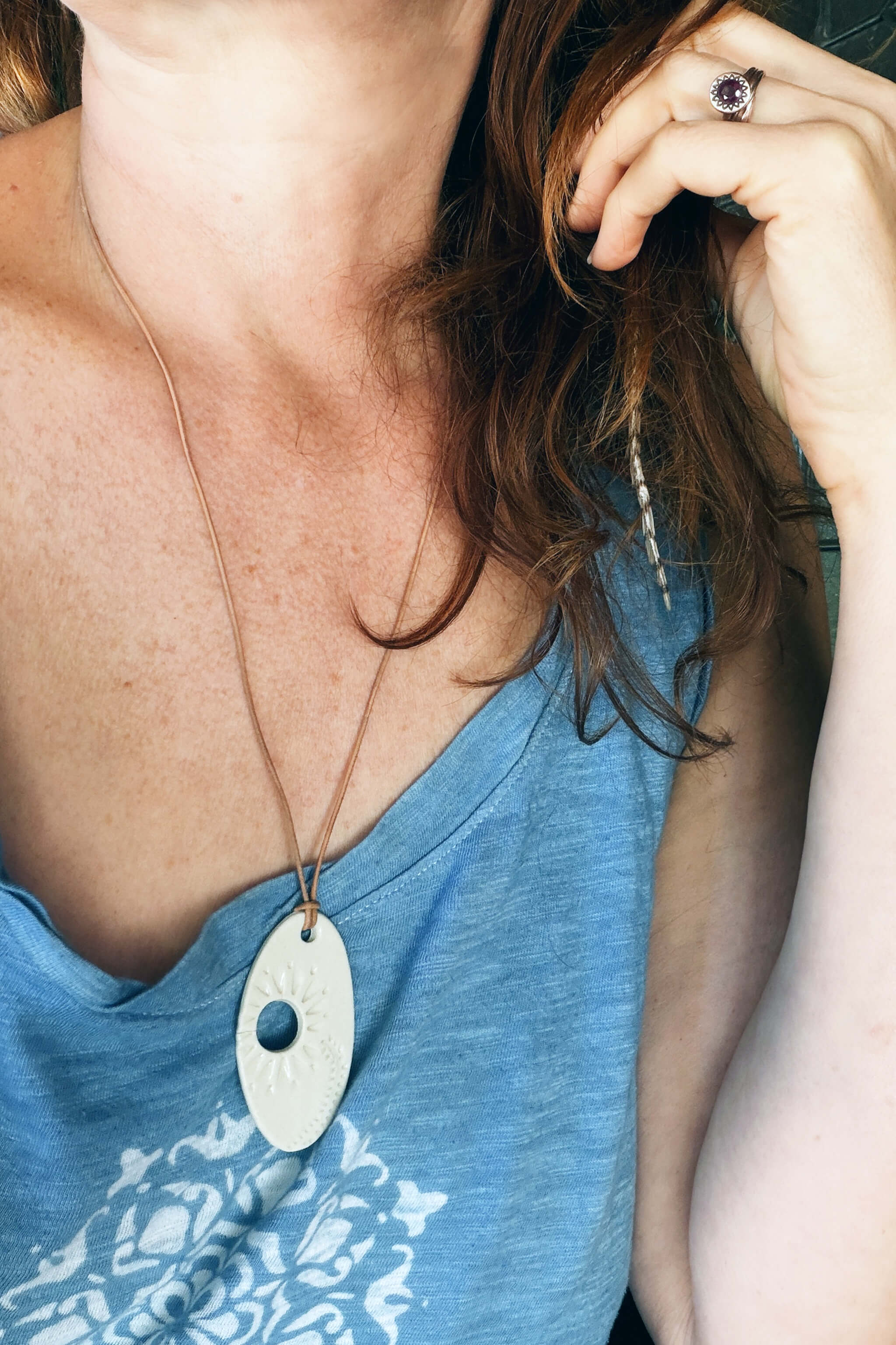 Handmade white porcelain floral ceramic pendant necklace worn long and boho on camel Italian leather — From the Fire FTF_0726 by Jester Swink