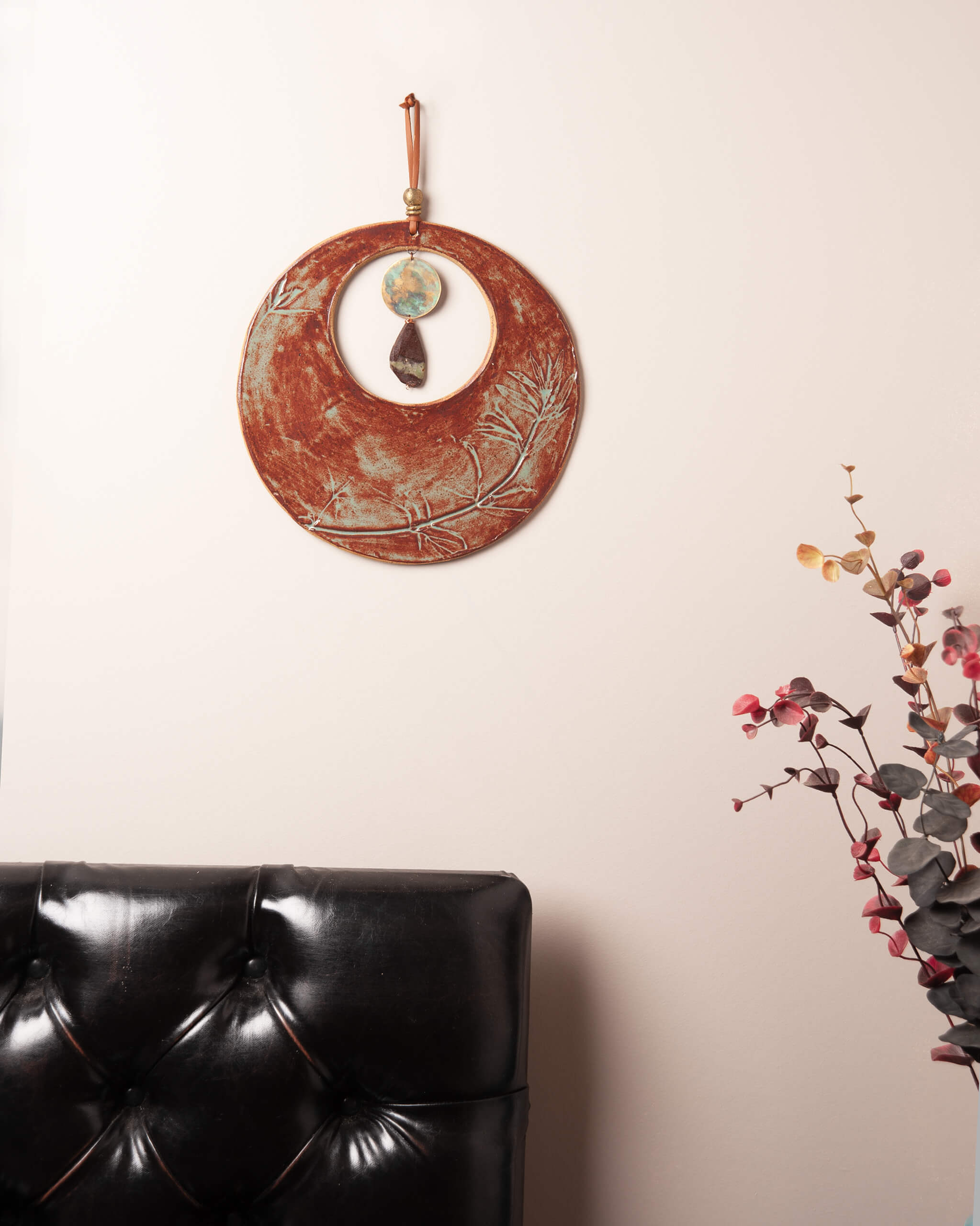 Crescent Blood Moon large ceramic wall hanging displayed in home setting showing full dramatic rusty terracotta and sage glaze