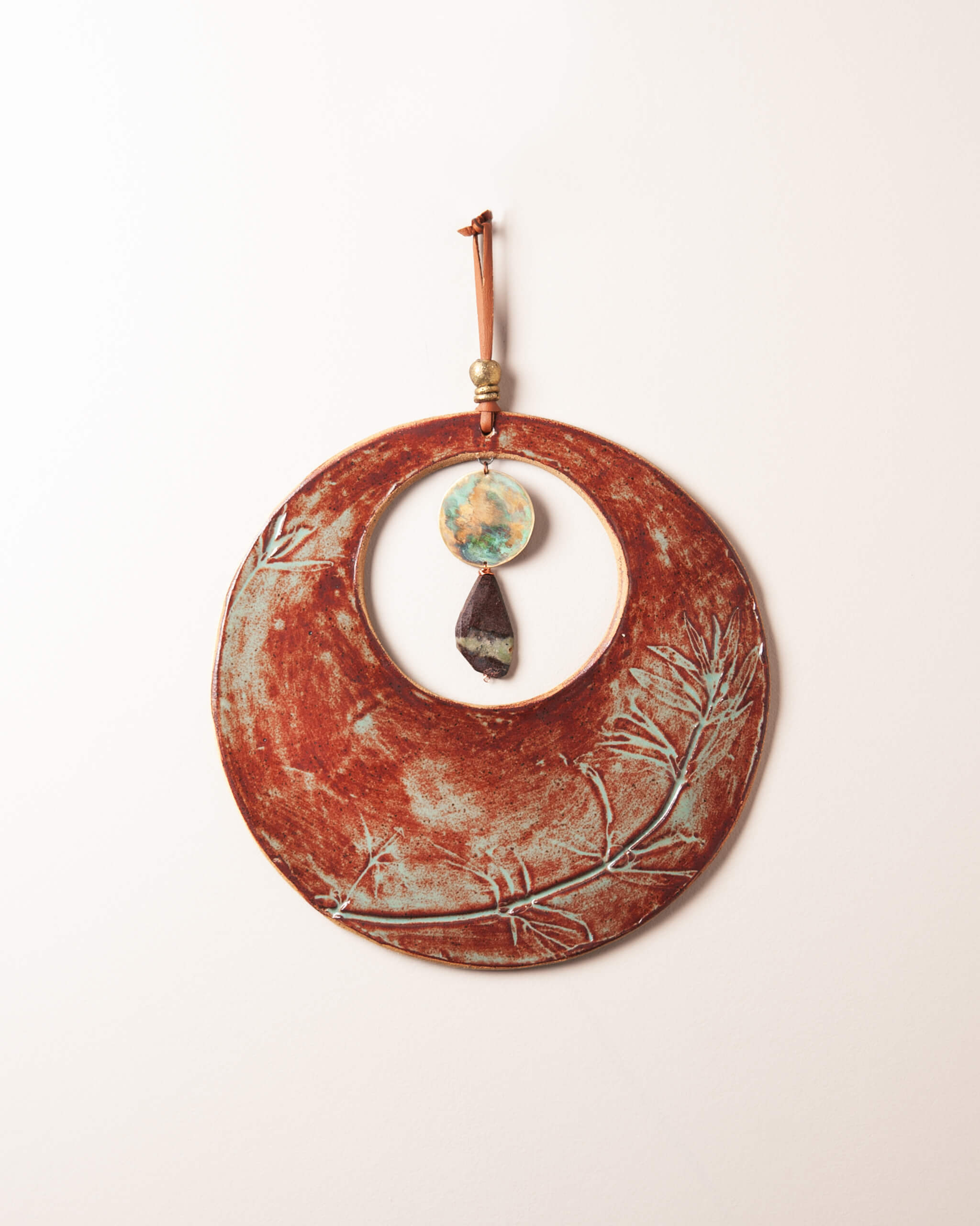 Crescent Blood Moon large handmade ceramic wall hanging with wildflower impression, rusty terracotta and sage glaze, hand patinated brass disc, made in the Santa Cruz Mountains of California