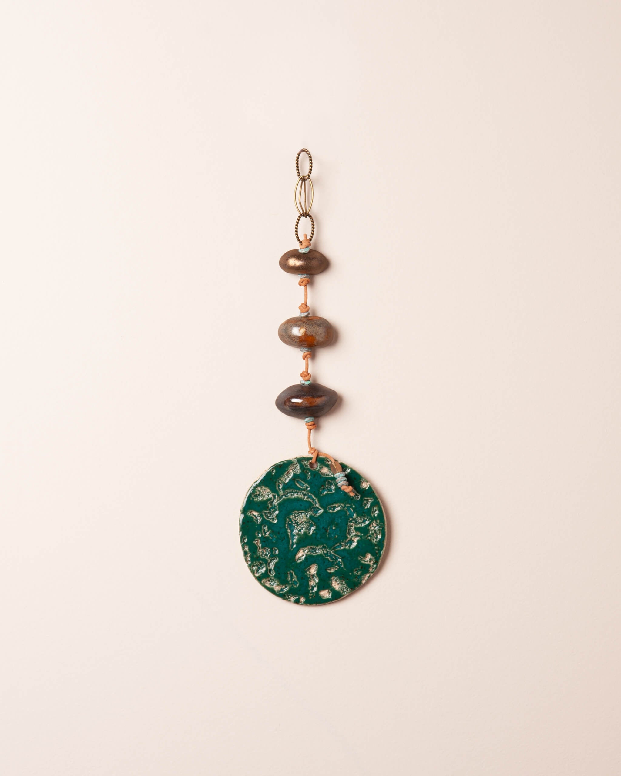 Emerald Tide Stack handmade ceramic wall hanging with river rock ceramic forms, coral and abalone impressions and deep emerald glaze, made in the Santa Cruz Mountains of California