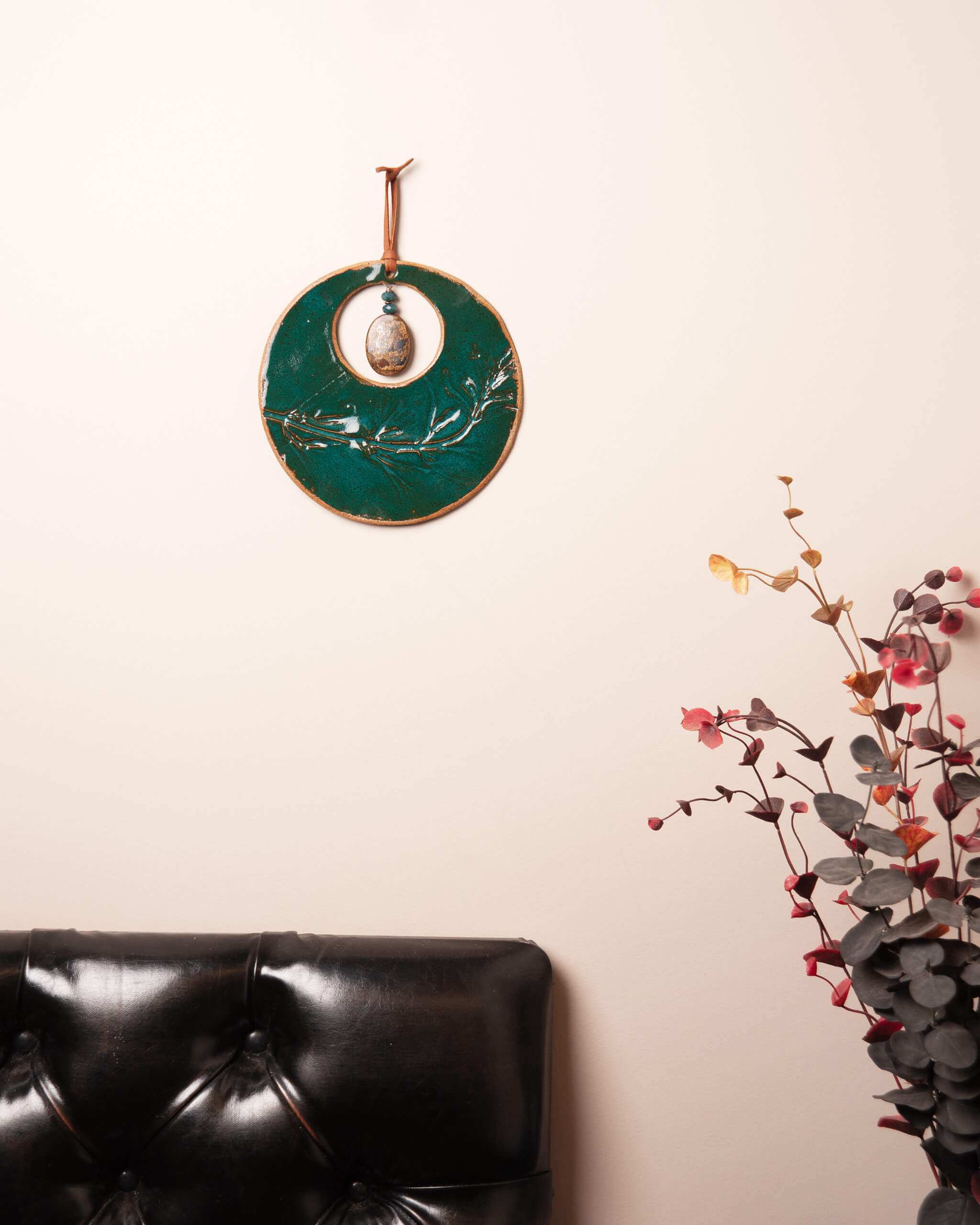Emerald Wildflower Moon handmade ceramic wall hanging in home setting