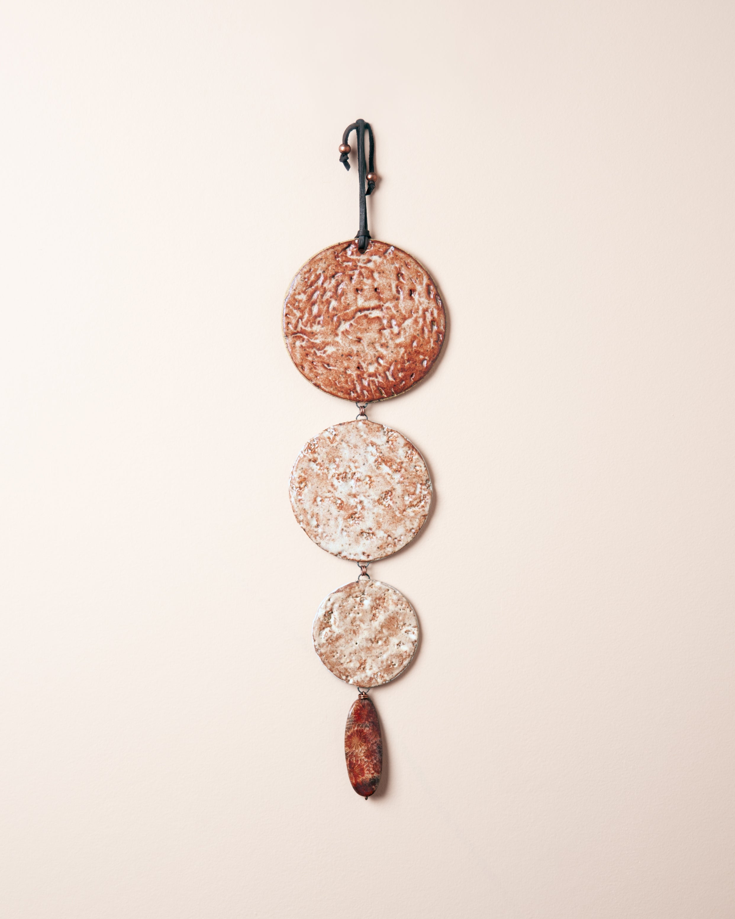 Forest to Shore Cascade handmade ceramic wall hanging with three graduating discs, redwood bark abalone and coral impressions, made in the Santa Cruz Mountains of California