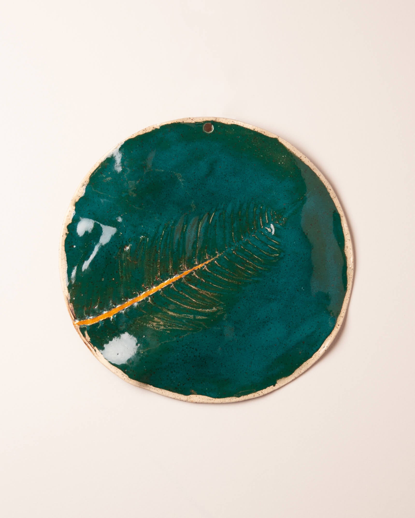 Golden Fern handmade ceramic wall plaque with fern impression, emerald glaze and kintsugi gold crack, made in the Santa Cruz Mountains of California