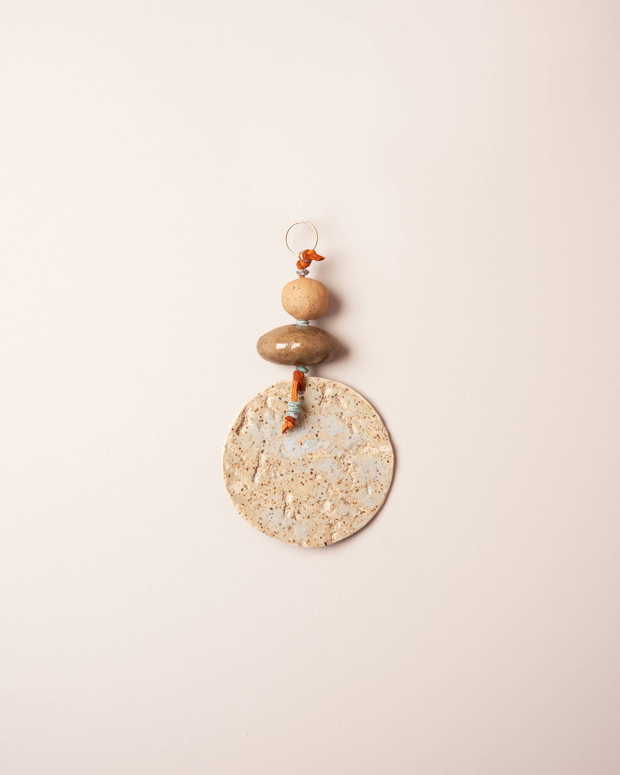 Ice Shore Stack small handmade ceramic wall hanging with abalone and coral impressions, ice blue glaze and river rock ceramic forms, made in the Santa Cruz Mountains of California