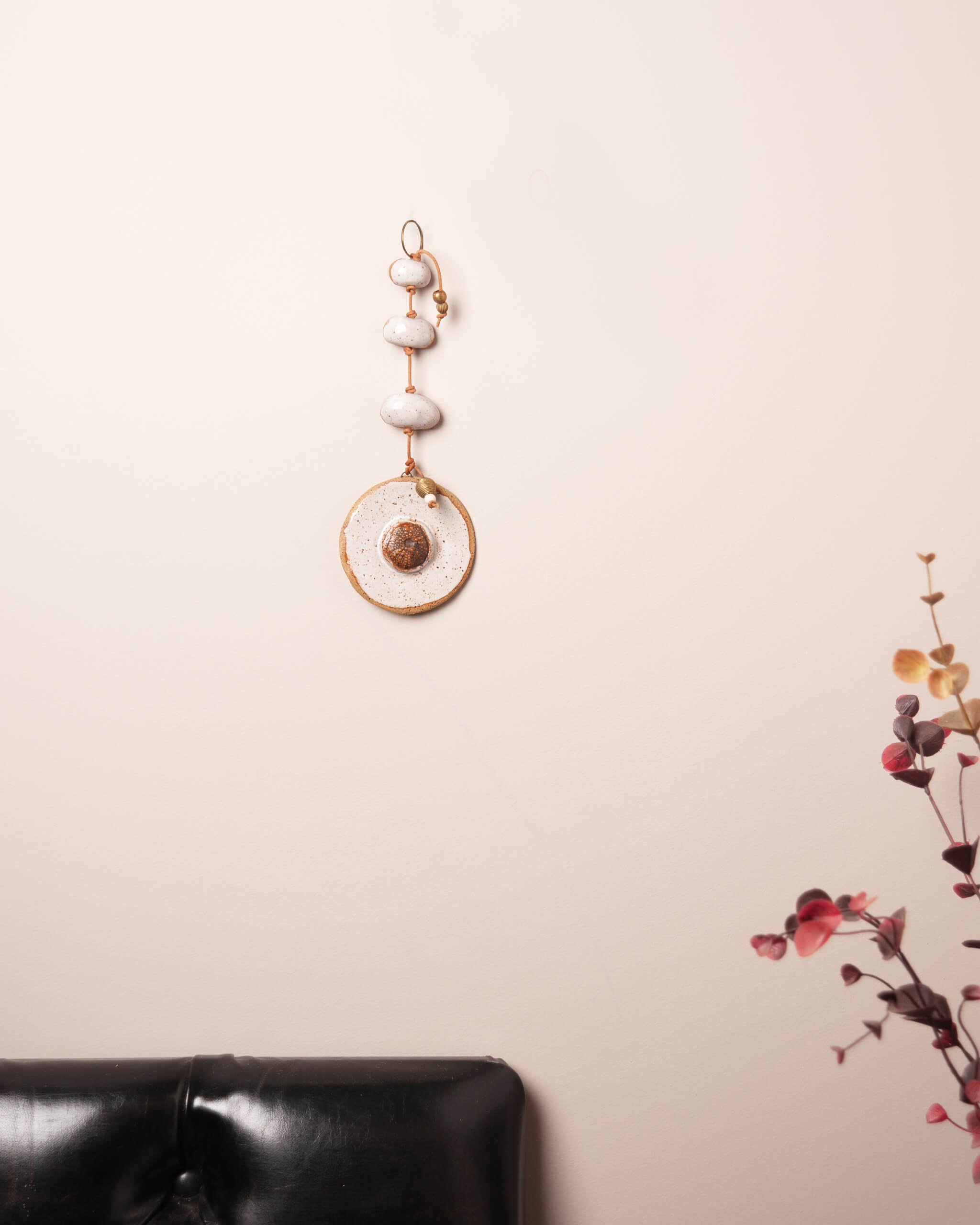 Sea Urchin Stack ceramic wall hanging displayed on wall showing full vertical stack construction and river rock forms