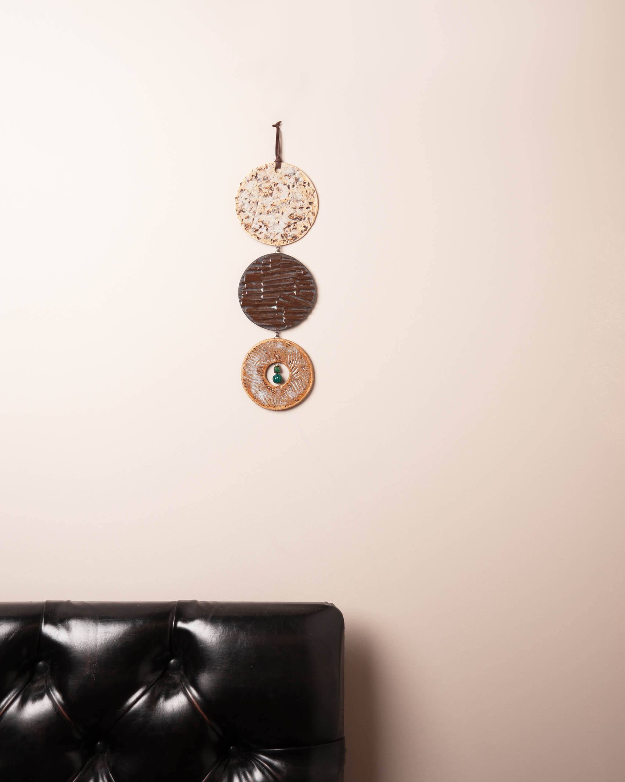 Terra Strata Cascade ceramic wall hanging displayed in home setting showing full three disc cascade and dramatic clay body contrast
