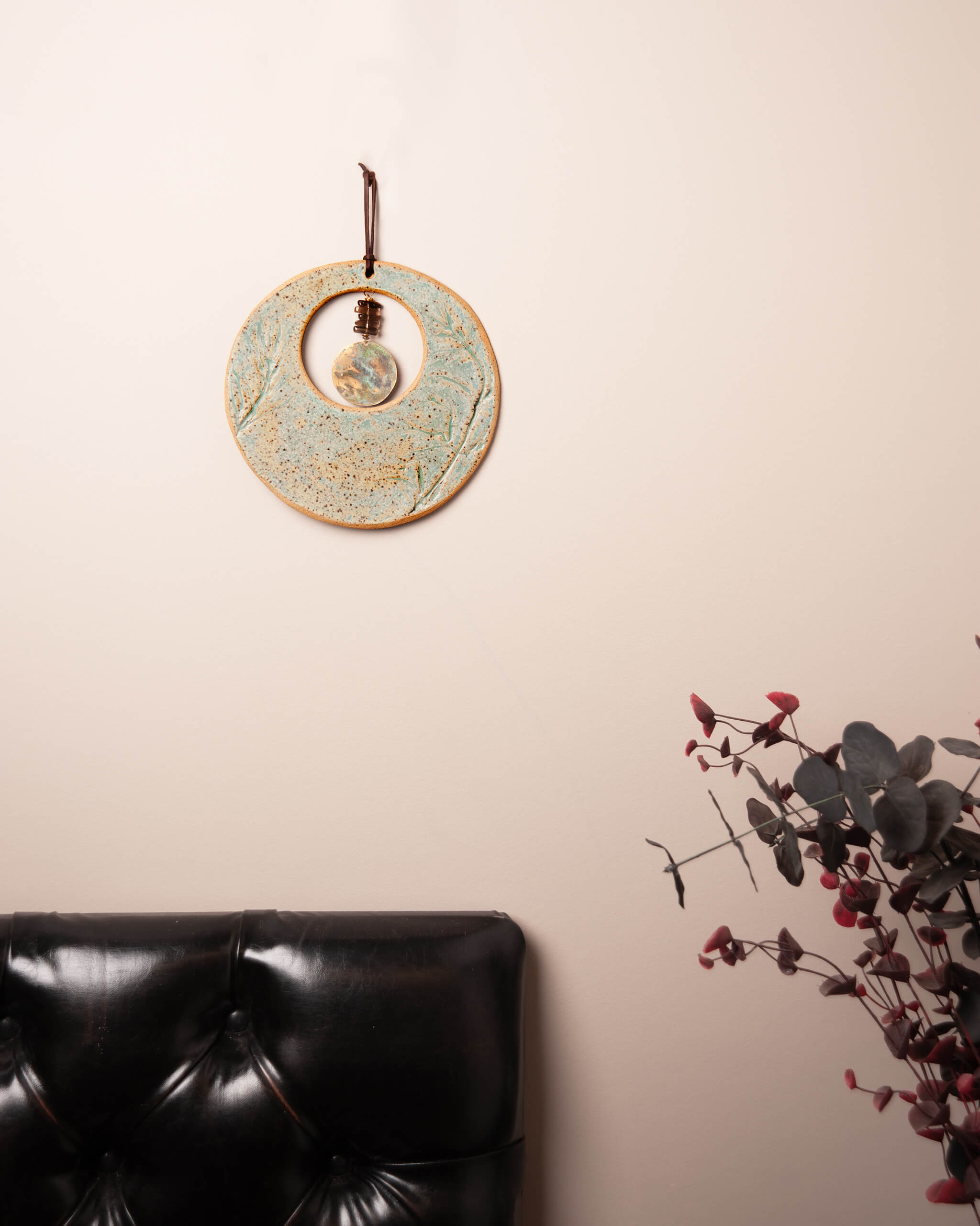Wild Sage Moon handmade ceramic wall art with smoky quartz and patinated brass in natural home setting