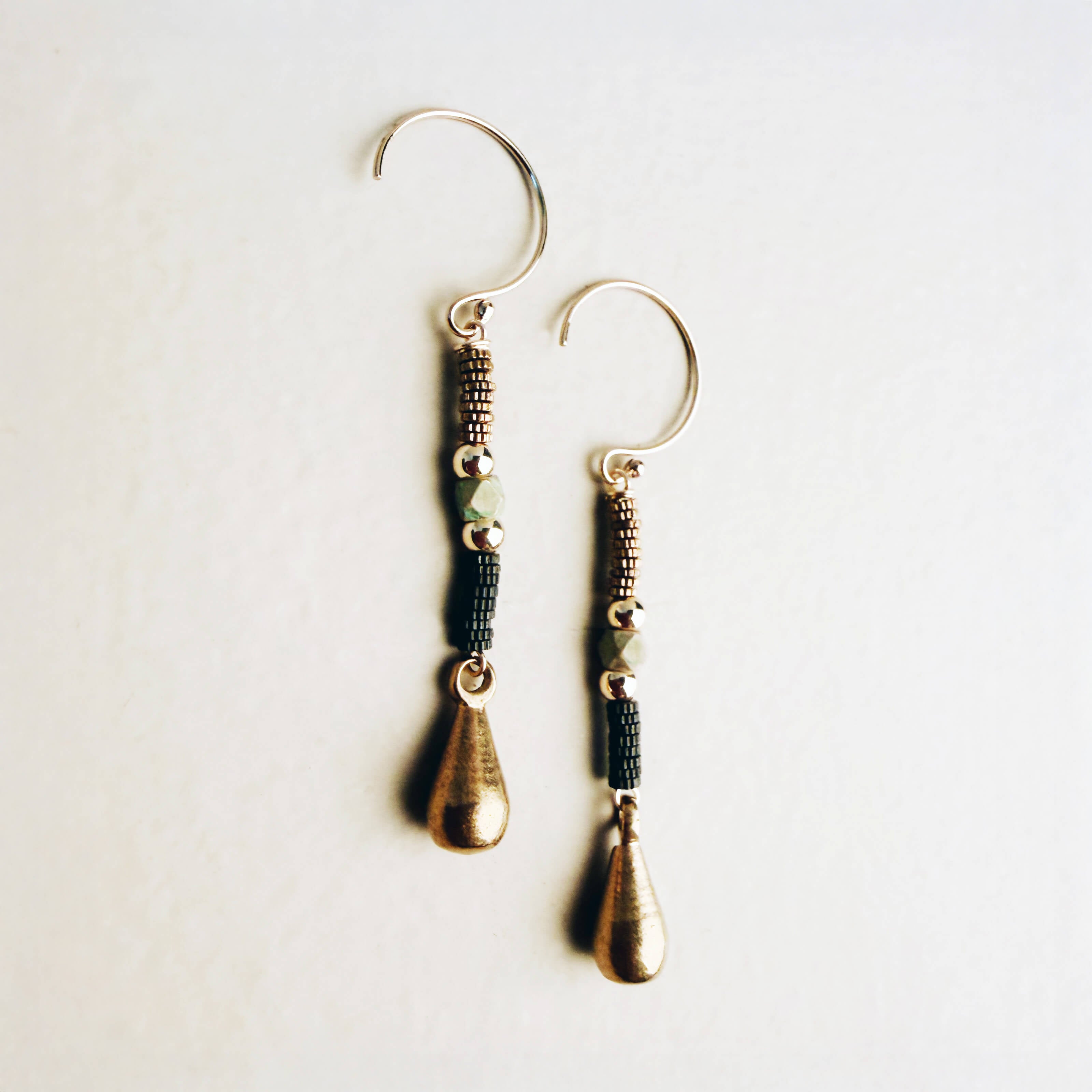 Pair of handcrafted artistic dangle earrings featuring brass teardrops, patina beads, and gold-filled accents, 2.25 inches long