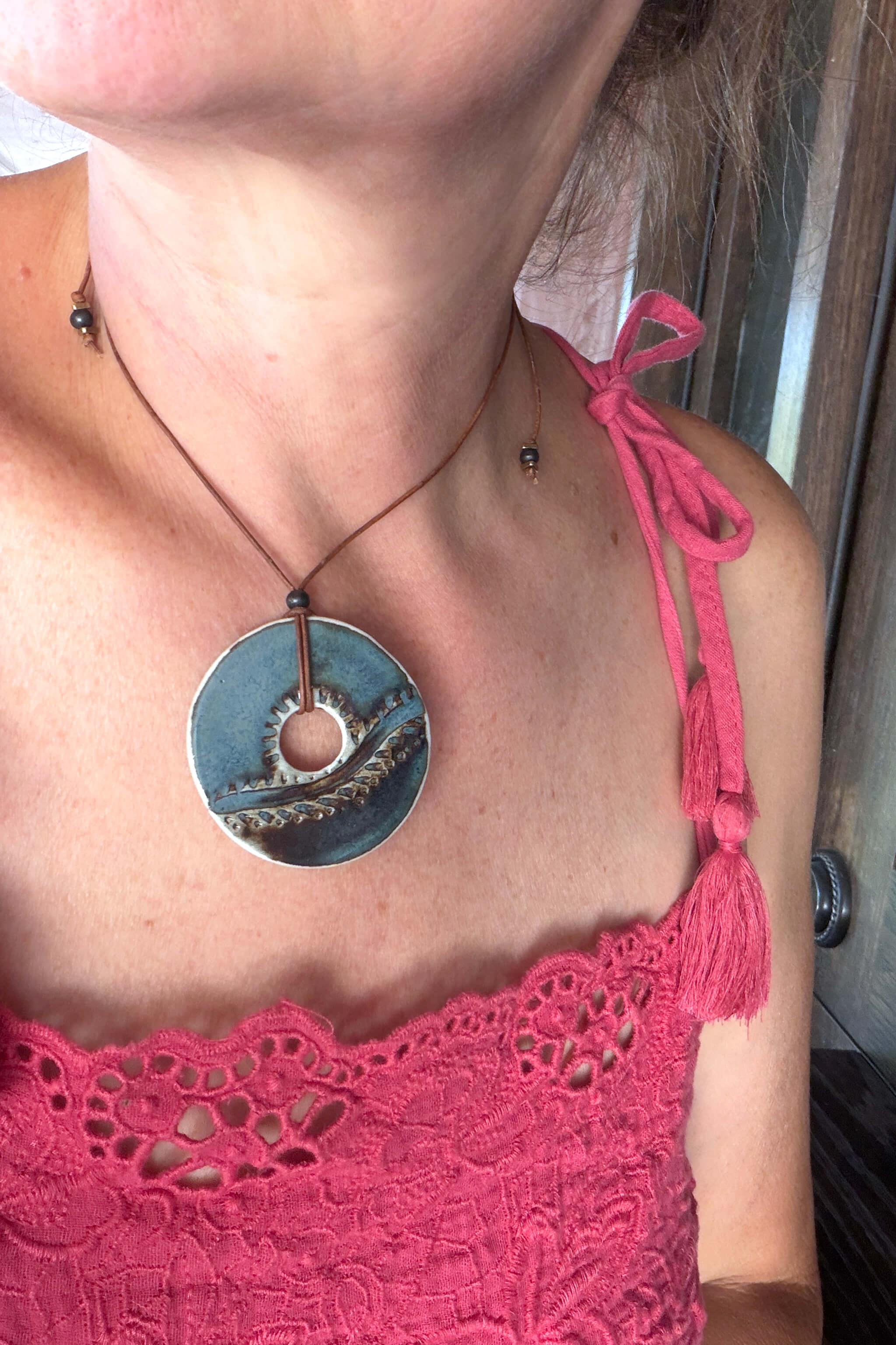 Handmade ceramic sunrise horizon pendant necklace worn at shorter length — ocean inspired ceramic jewelry From the Fire FTF_0726 by Jester Swink