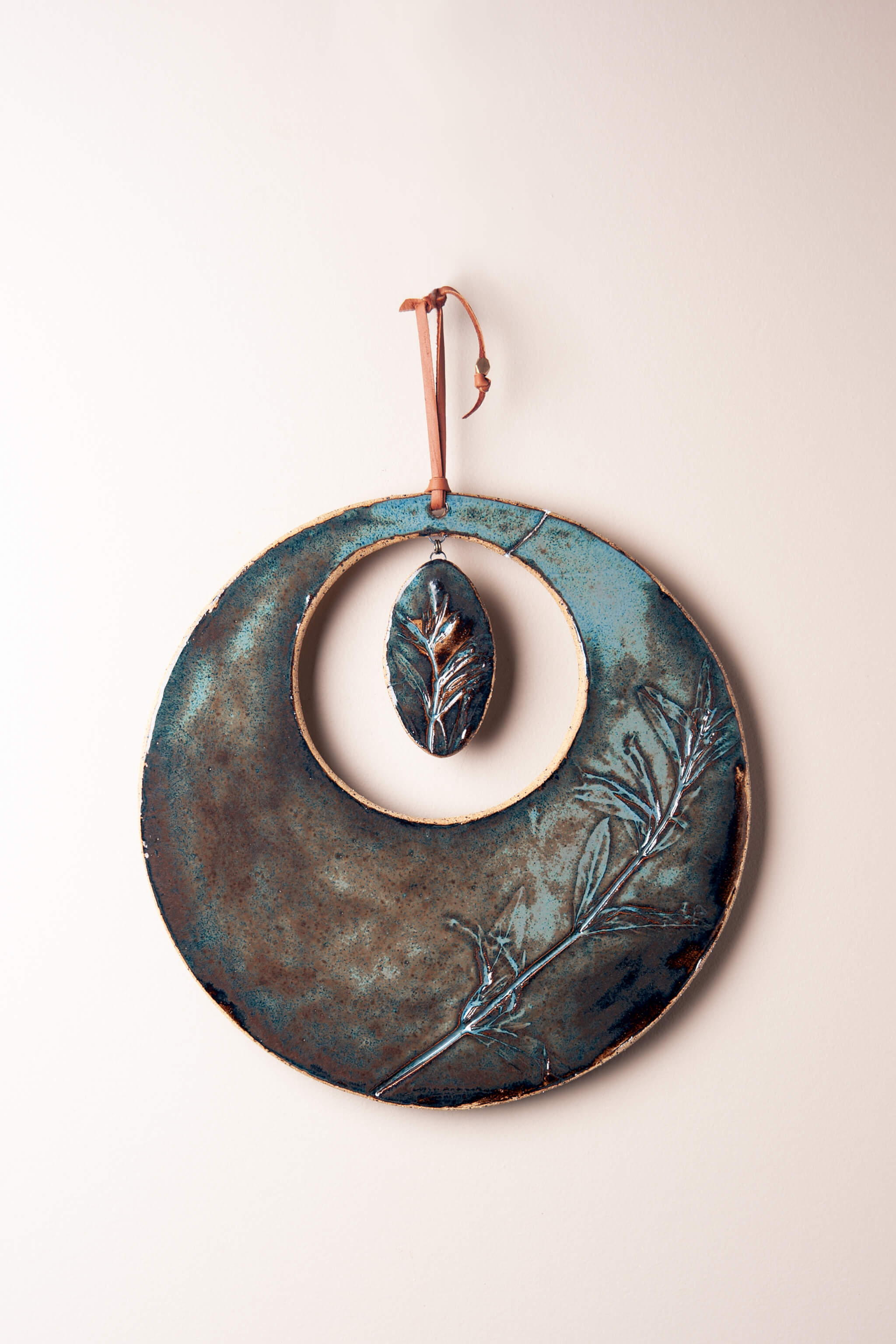 Large handmade circle ceramic wall hanging in aqua marine glaze with monkey flower impression, kiln fired by Jester Swink Santa Cruz Mountains — From the Fire FTF_0726