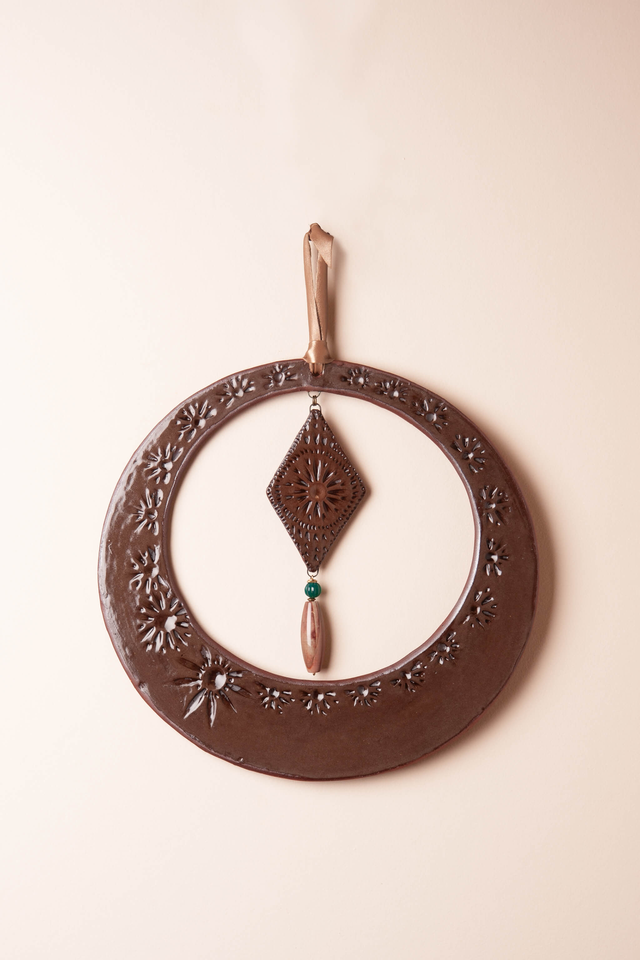 Large handmade circle ceramic wall hanging in rich chocolate brown glaze with mountain jasper and green onyx, kiln fired by Jester Swink Santa Cruz Mountains — From the Fire FTF_0726