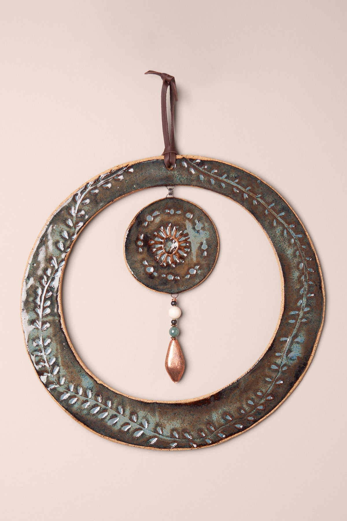 Large handmade circle ceramic wall hanging in Sea Breeze glaze with hand pressed vines, a pressed sun and an aventurine and mountain jasper dangle, kiln fired by Jester Swink Santa Cruz Mountains — From the Fire FTF_1026