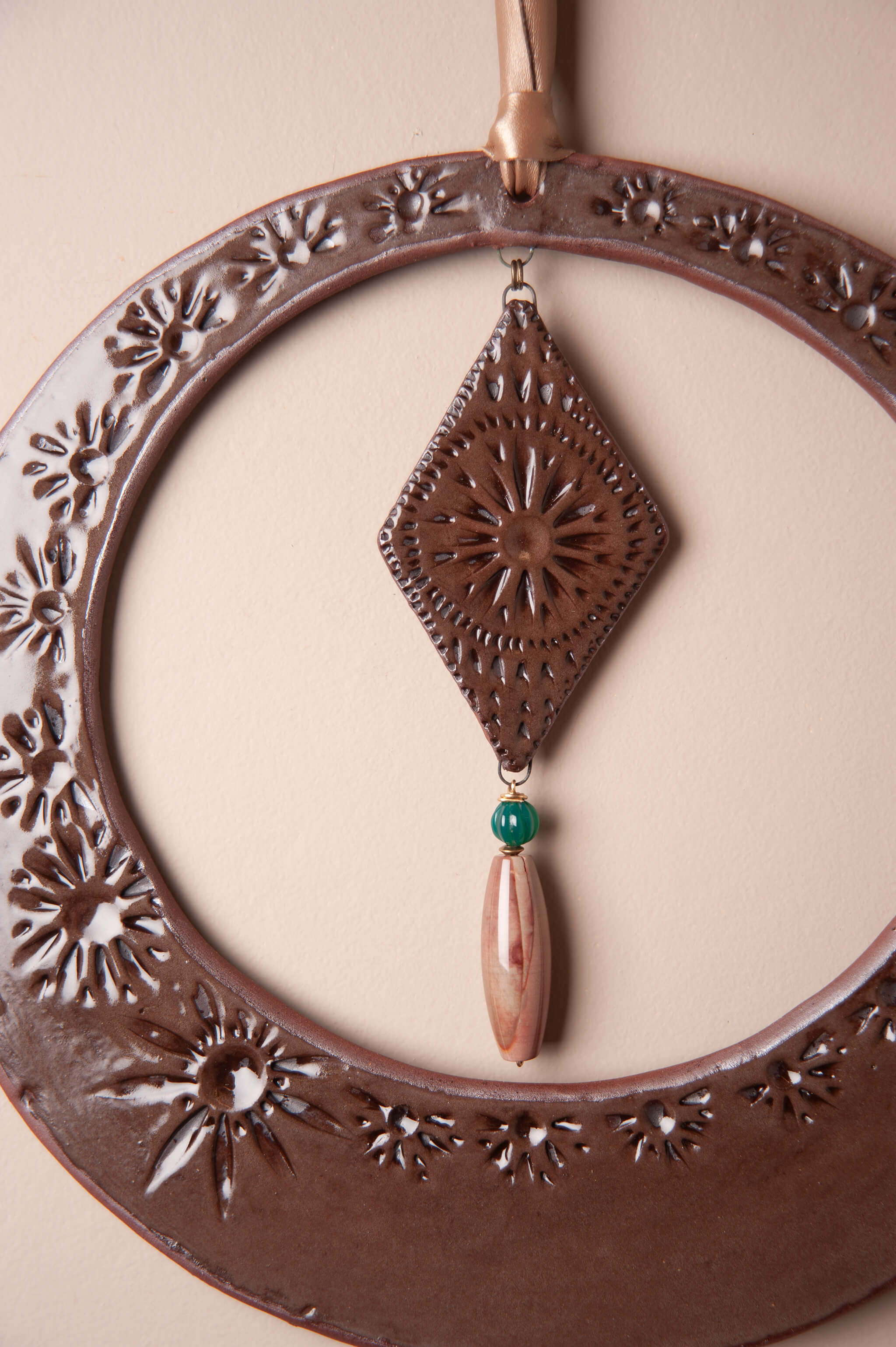 Detail of hand impressed tool pattern on large handmade ceramic wall hanging by Jester Swink, Santa Cruz Mountains California