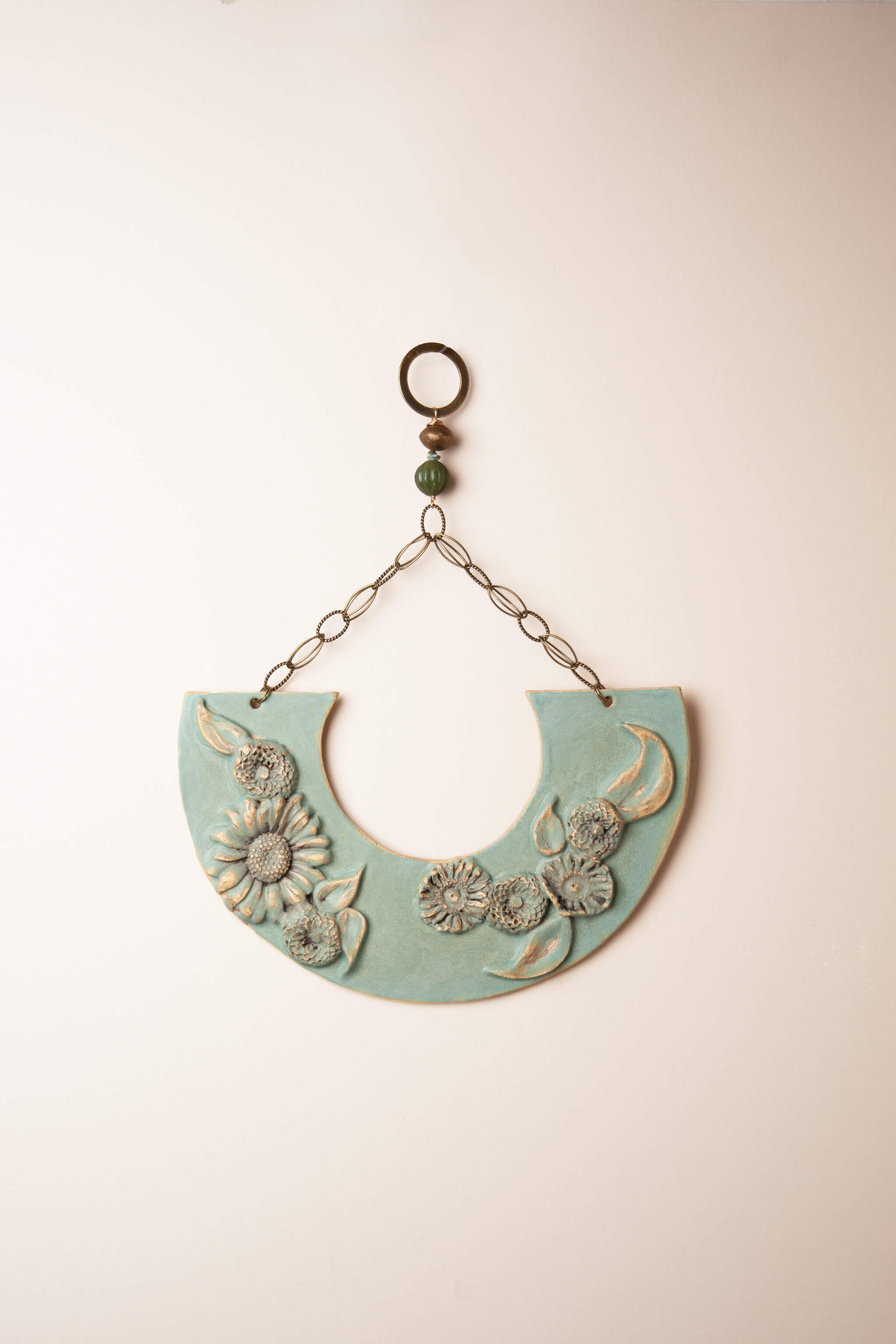 Large handmade floral ceramic wall plaque in seafoam sage green with dimensional flowers and serpentine bead, kiln fired by Jester Swink Santa Cruz Mountains — From the Fire FTF_0726