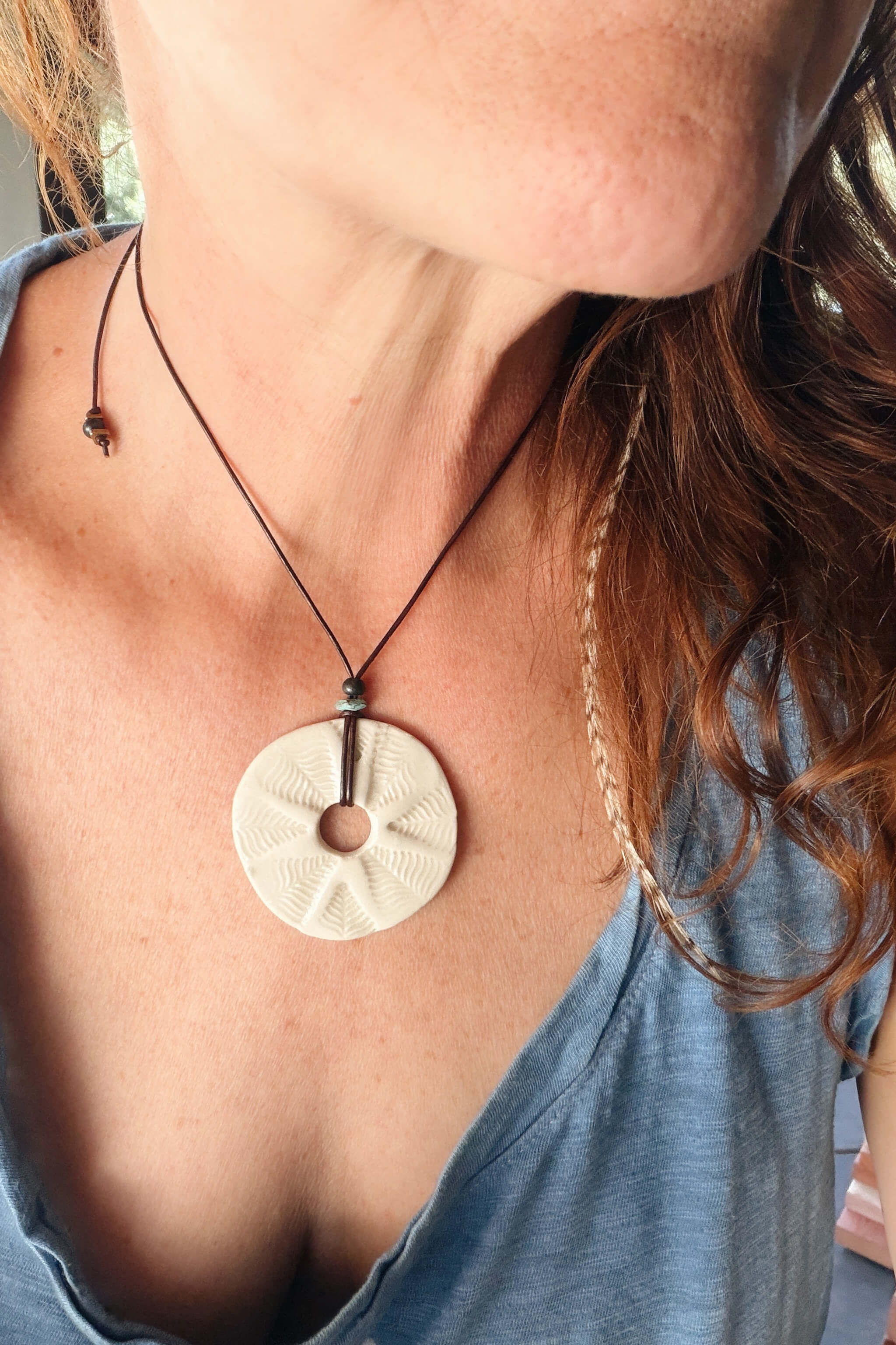 Handmade white ceramic leaf mandala pendant necklace worn at shorter length — boho ceramic jewelry From the Fire FTF_0726 by Jester Swink