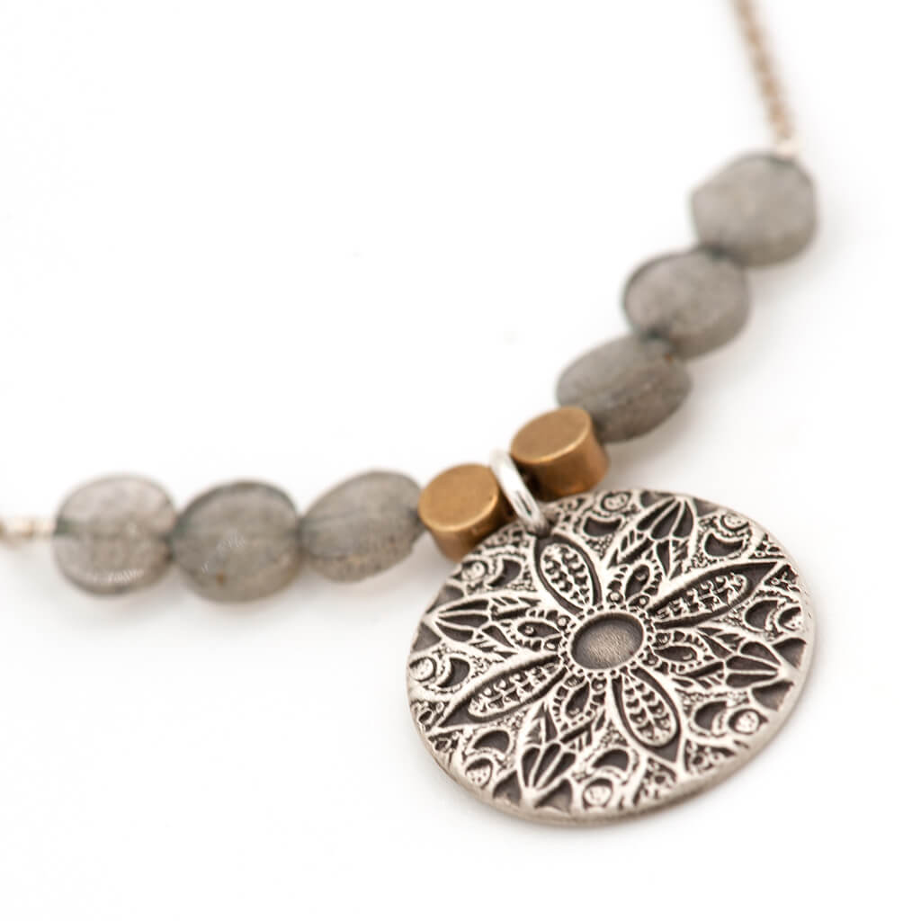 Close-up of handcrafted sterling silver mandala pendant with labradorite stone — artisan mandala harmony necklace by Jester Swink